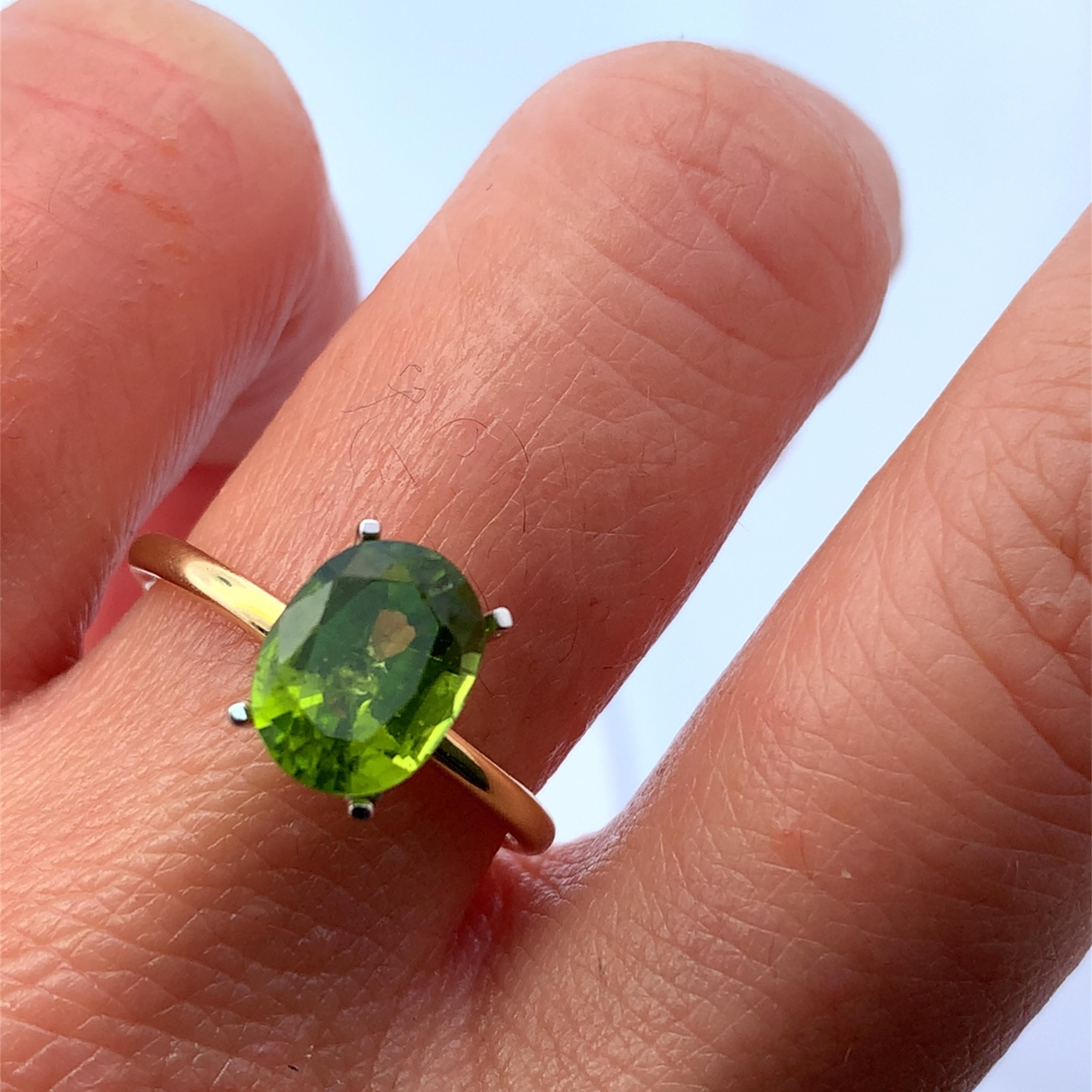 This stunning ring features a vibrant green peridot 2.55ct gemstone, elegantly set in a delicate 18k yellow gold band. The unique color of the stone captures the light beautifully, making it a perfect accessory for any occasion. Whether you're