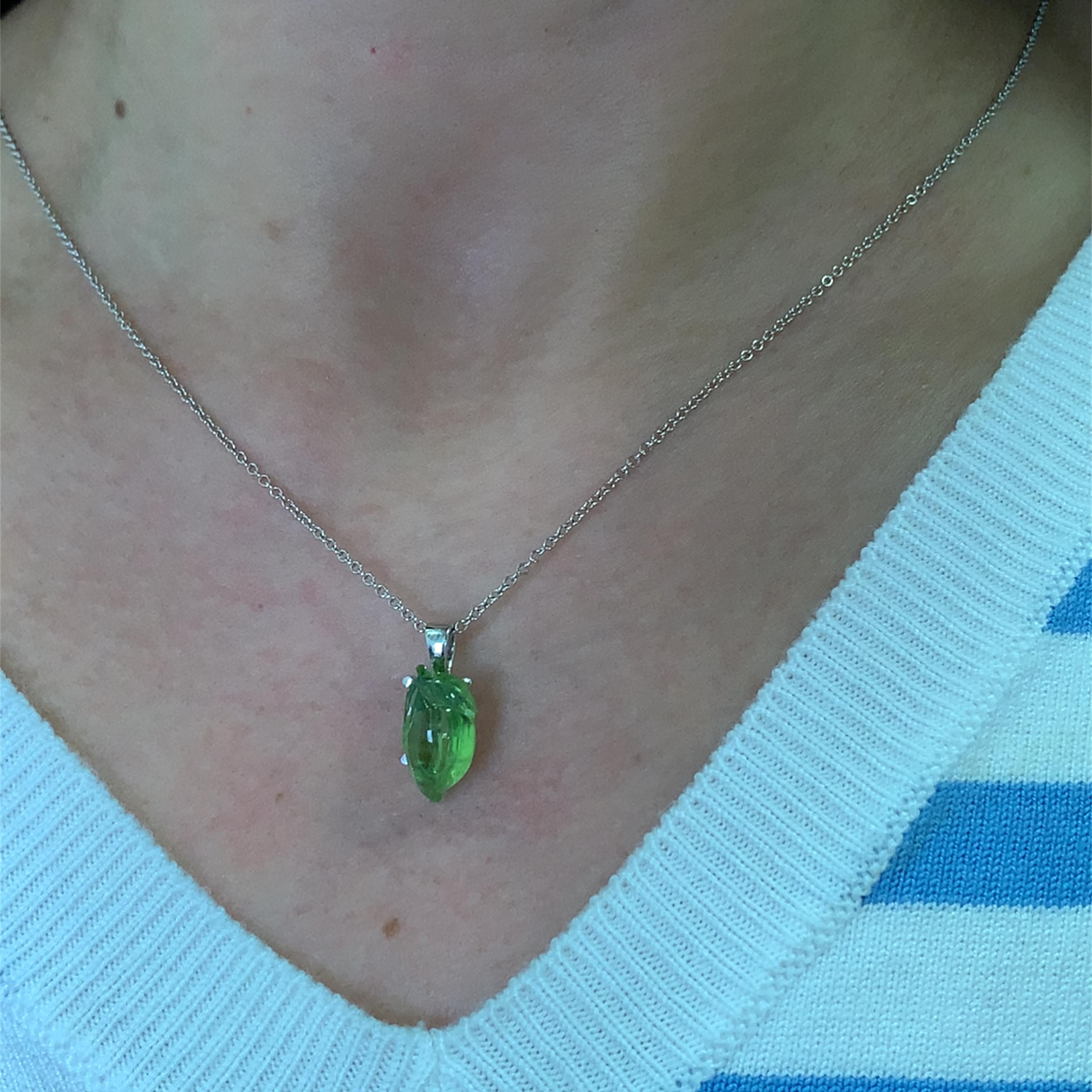 This stunning green peridot 5.10ct gemstone Amalfi lemon shaped pendant is a true statement piece. Crafted with precision, it features a vibrant lemon-cut gemstone  measuring approx 15/9mm that catches the light beautifully. The delicate 18k white