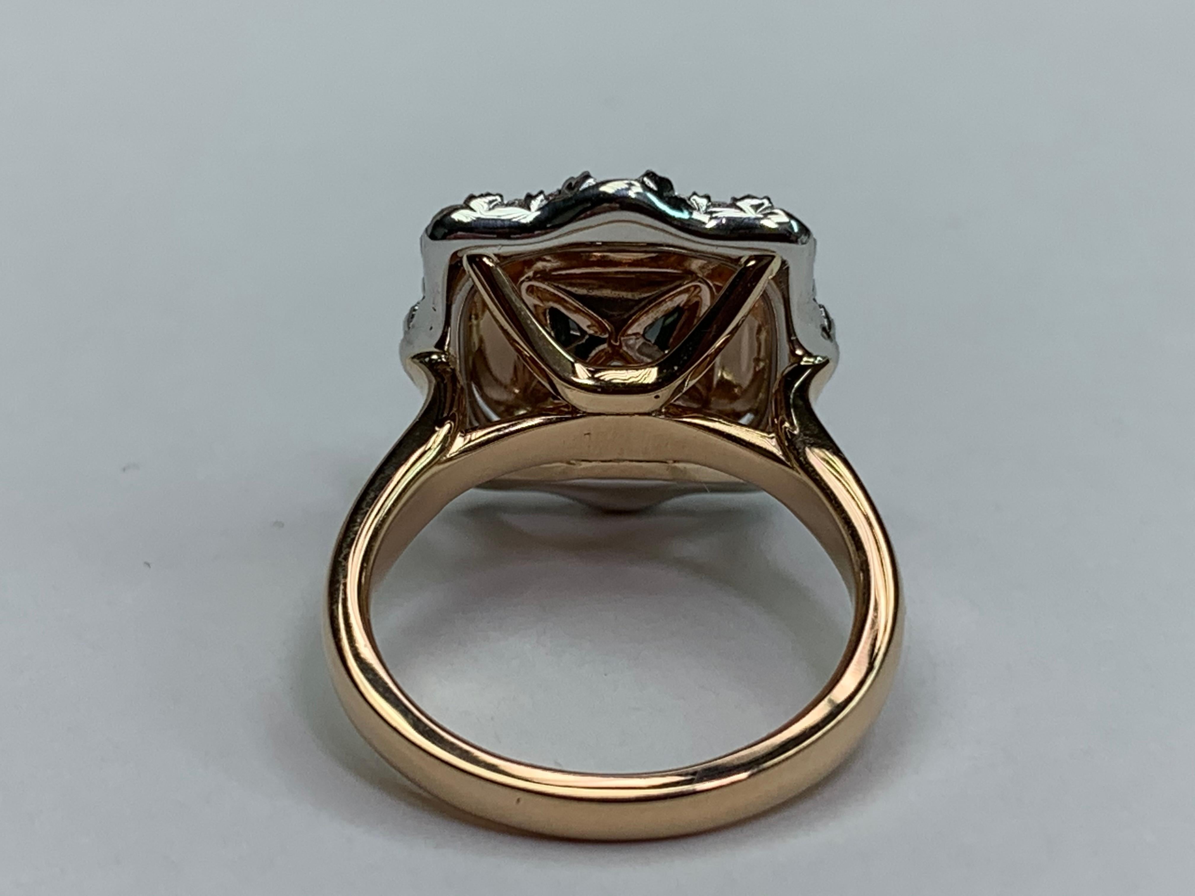 2.77 Carat Cushion Cut is set in the Center of this Ring. The 2.77 carat Cushion is not a certified Diamond. With that said, the Diamond color is Grayish Greenish in Color and SI Type in Clarity.The Center is surrounded by one Raw of Pink Diamonds,