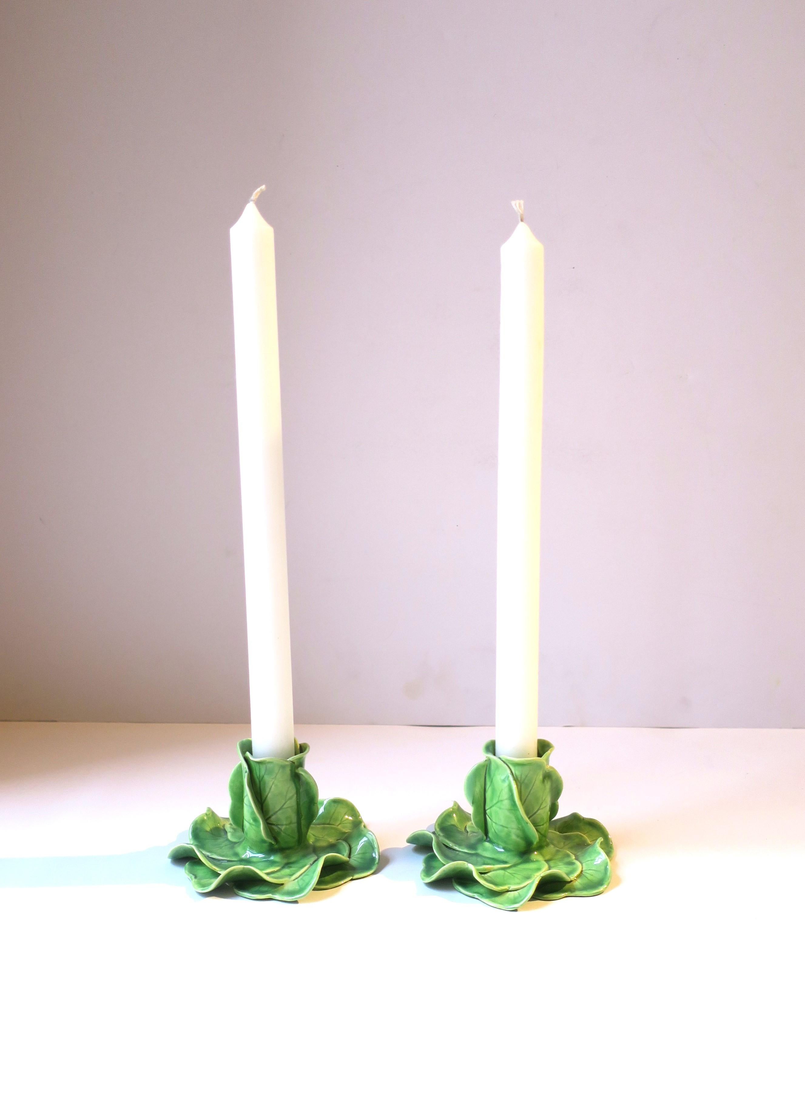 A beautiful set of green porcelain lettuce leaf candlestick holders styled after American designer, Dodie Thayer, circa late-20th century, Australia. Marked on bottom as shown in last image, including designers' initials. A beautiful set to use
