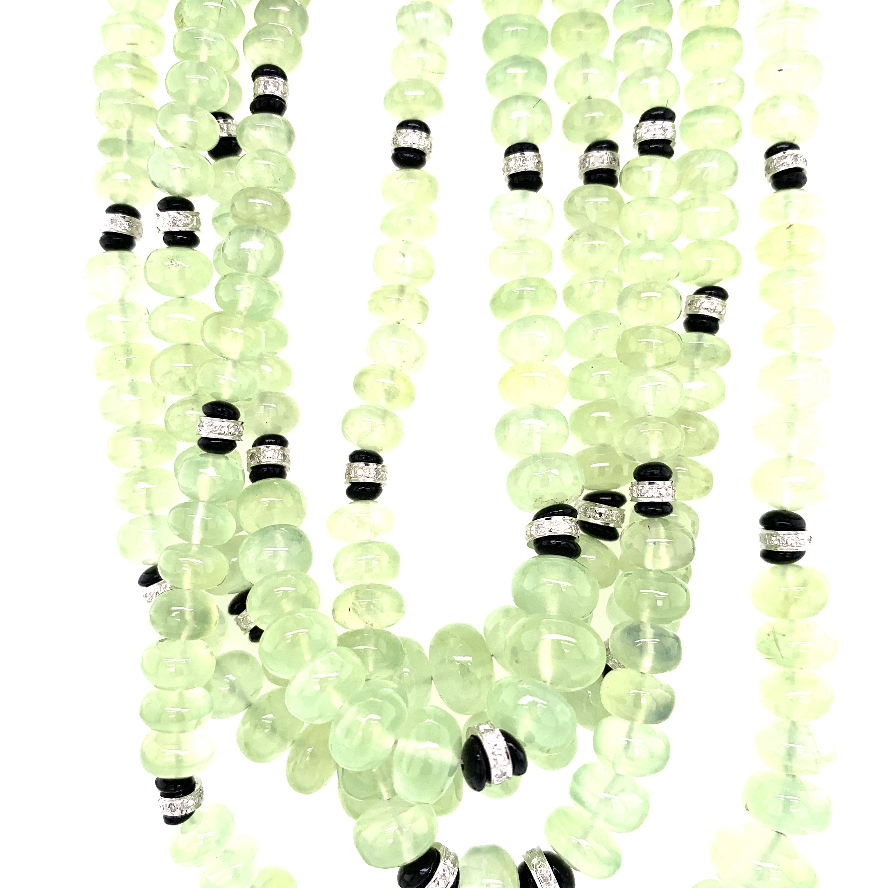Green Prehnite Beads and White Diamond Clasp Gold Multi-Strand Necklace :

An unusual and beautiful necklace, it features hard-to-find green prehnite beads weighing 945.09 carat, with 50 white round brilliant diamond rondelles interspersed between