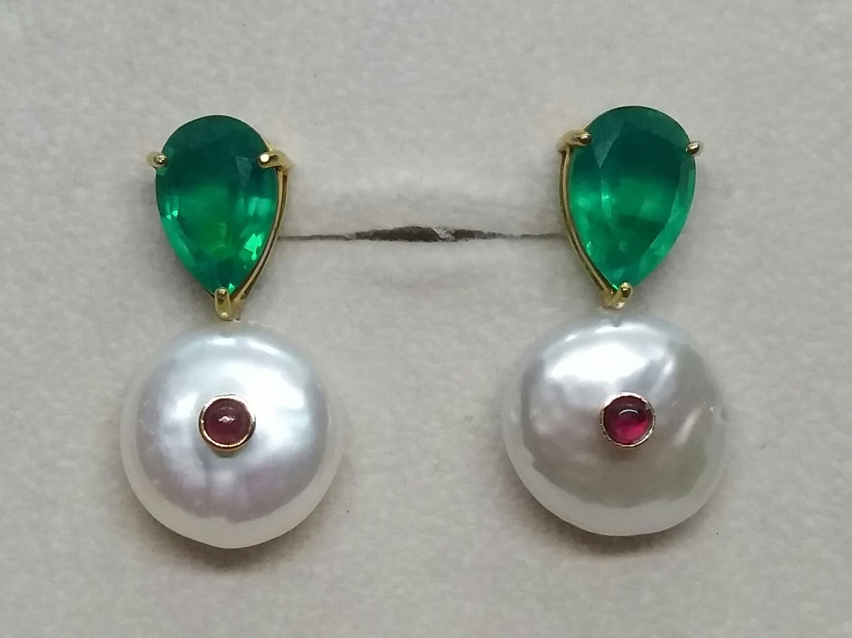 Simple chic stud earrings with a pair of  Green Quartz faceted pear shape set in solid 14 Kt. yellow gold on the top and 2 Round Flat Fresh water pearls 15 mm in diameter with in the center a small round Ruby cab also set in yellow gold 

In 1978
