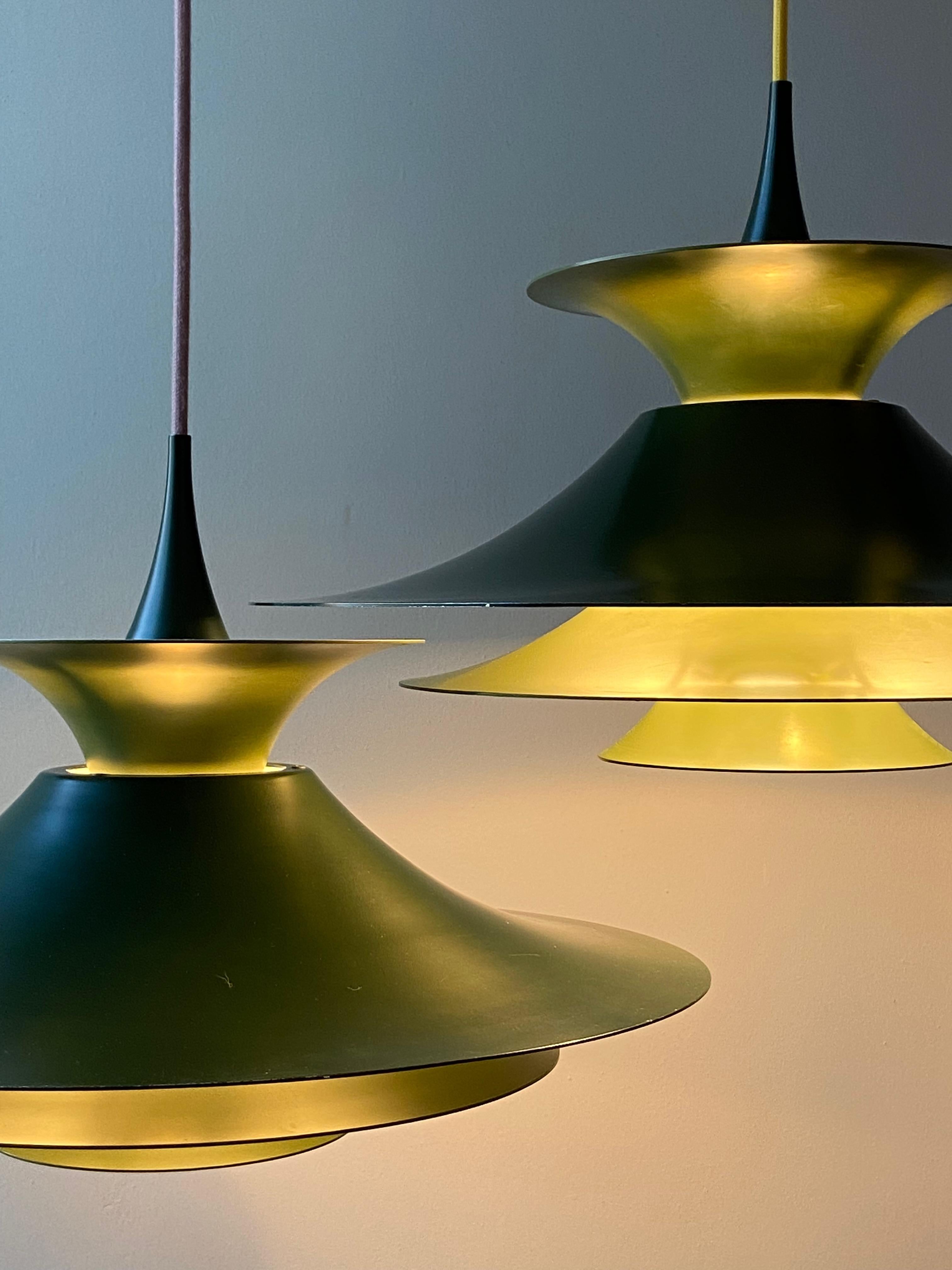 Radius 1 pendant by Erik Balslev. Dark and light green shades inside white lacquered aluminium. Produced by Fog & Mørup. Measures: 48 cm diameter version with E26/27 Edison socket. No parts missing (with reflector) ! With new yellow fabric cord.