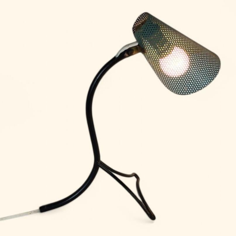 1950s modernist table lamp in the style of / attributed to Mathieu Matégot (1910-2001).

The lamp is made of solid lacquered metal with a dark green lacquered 