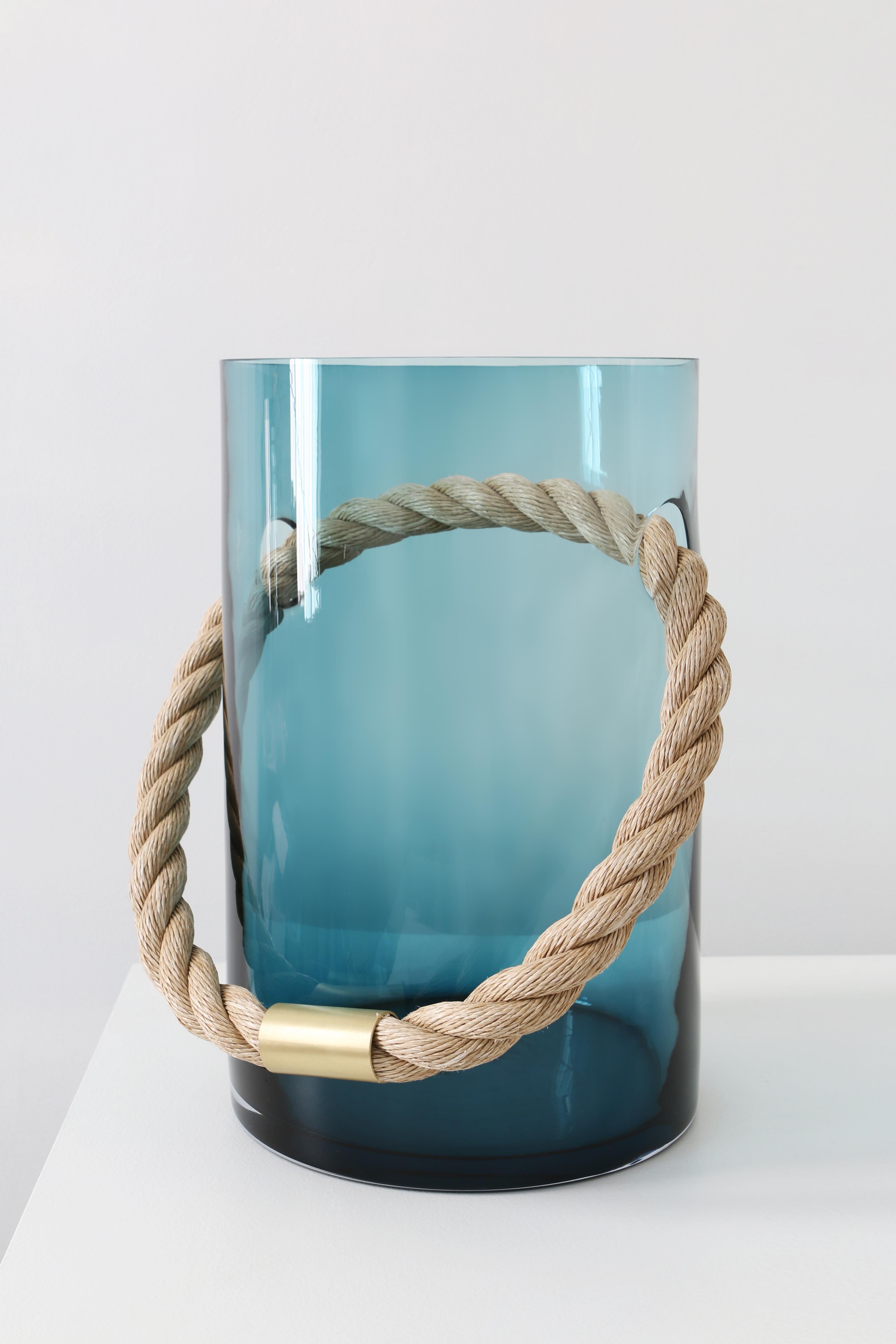 Green rope vessel by SkLO
Dimensions: D 29 x H 50 cm
Materials: Glass, brass
Available in clear, pine tree green and smokey brown.
Available in 4 metal finishes: dark oxidized, polished nickel, brushed nickel, brushed brass.

Oversized