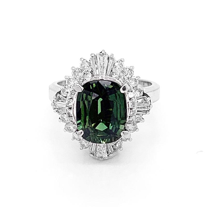 One of my favorite pieces in our collection. Sapphire comes in every color in the rainbow but green is more difficult to find in a pleasant shade and large size. This platinum ring features a 3.59 carat natural green sapphire with soft chrome like