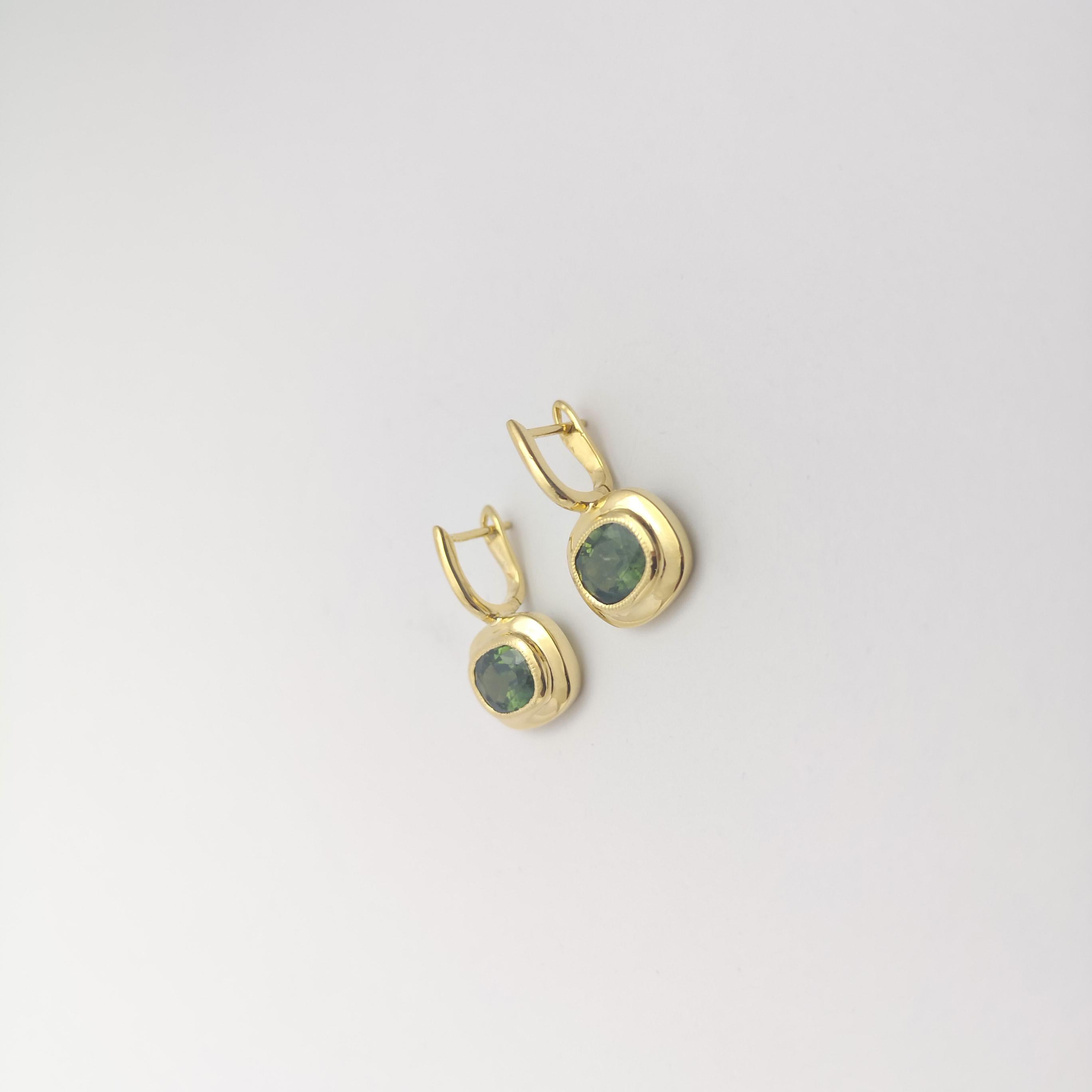 Oval Cut Green Sapphire Earrings set in 18K Gold Settings For Sale