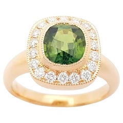 Anello con zaffiro verde e diamante con montatura in oro rosa 18 carati