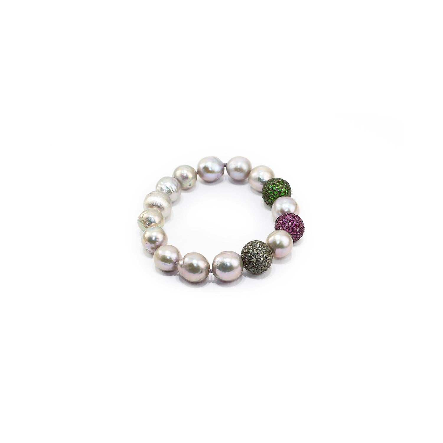 Nice bracelet made up of green sapphires, rubies and tsavorite pave on silver setting, baroque grey pearls and 925 satin silver clasp. 
Green sapphires pave ct. 1,79
Rubies pave ct. 2,26
Tsavorite pave ct. 2,07
Baroque grey pearls
925 satin silver