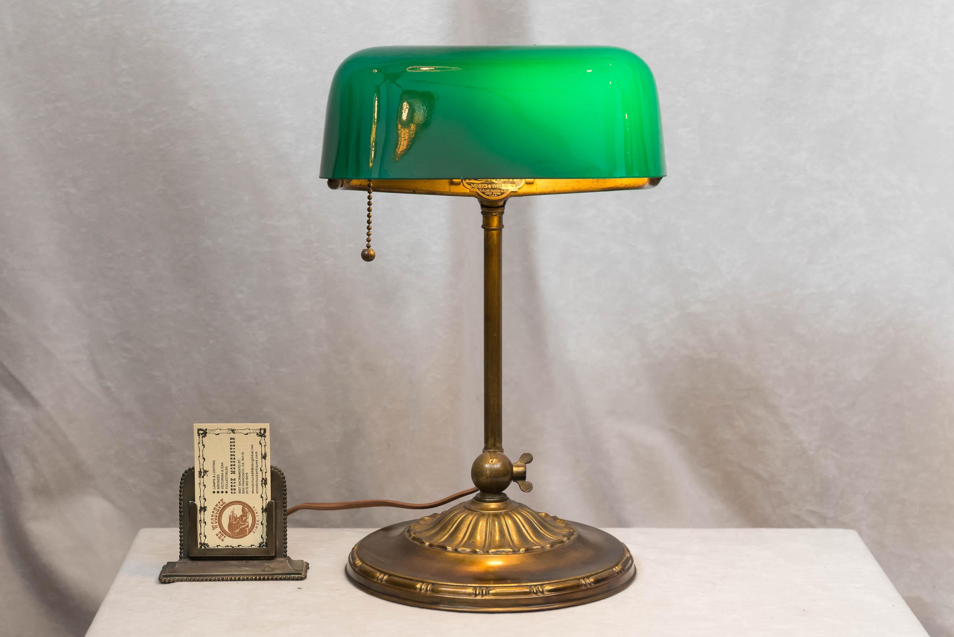 These Banker's lamps are one of our best selling items, when we can get them undamaged and with the original shade. The model was manufactured by the most well-known producer of these lamps, Emeralite. Signed on the shade and base, and having the