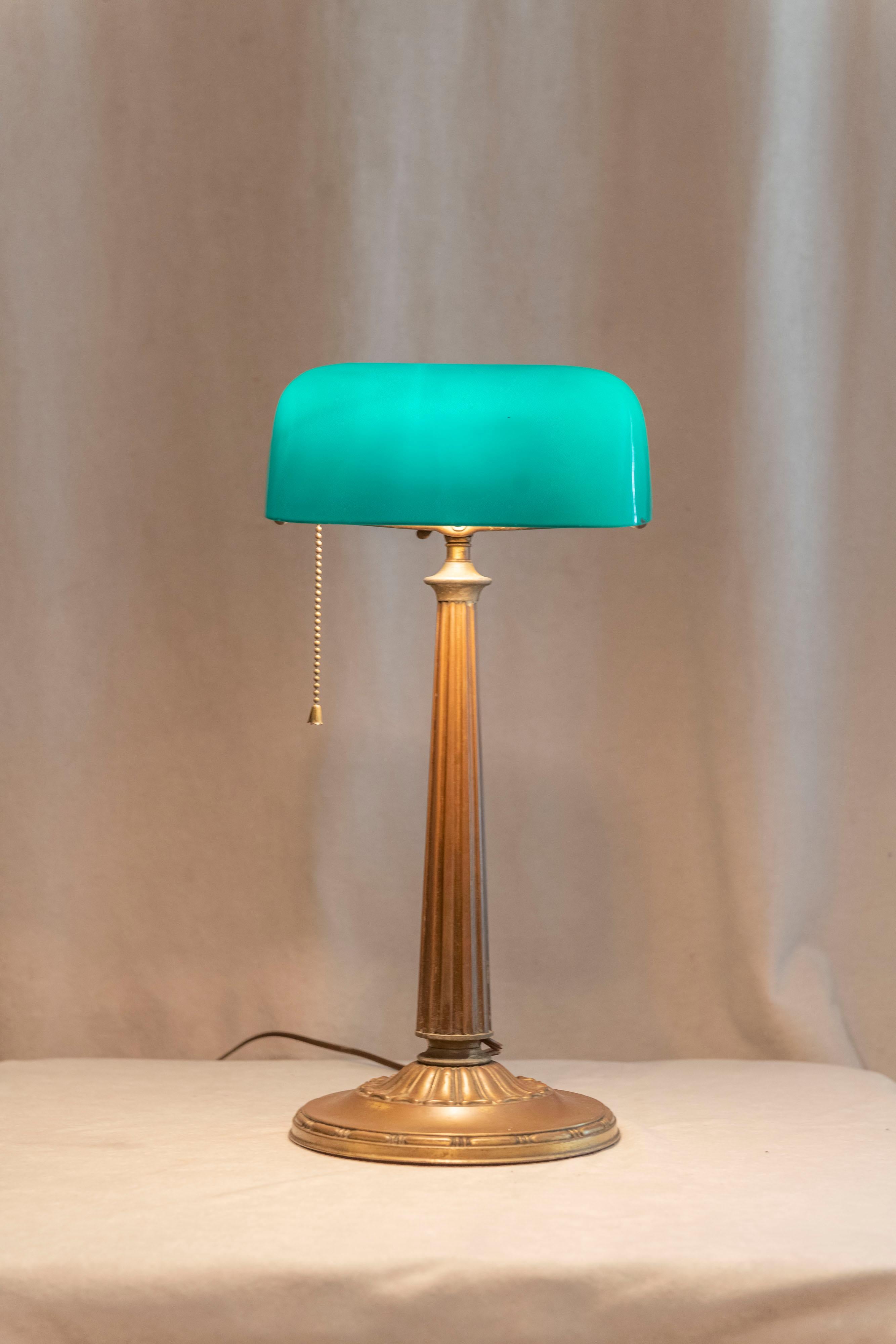 Emeralite was the premier maker of banker's lamps for many years in the early part of the 20th century. Factory patinated brass base, and the shade is what is known as 