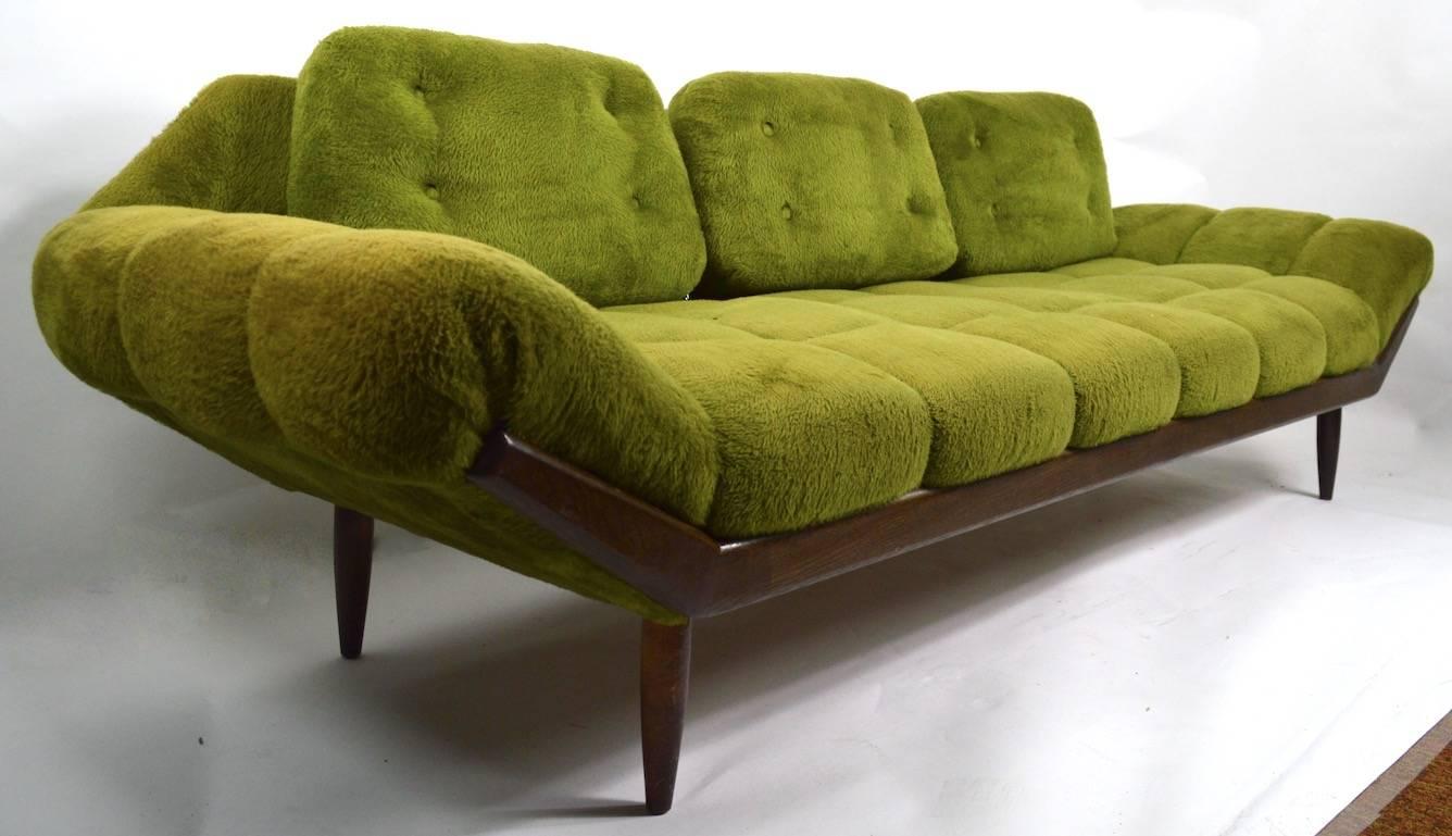 Funky green shag midcentury sofa. This example shows some cosmetic wear, notable to the upholstery, including one tufting button is missing fabric covering, as shown. Design after Adrian Pearsall, sold originally through regional retail outlet