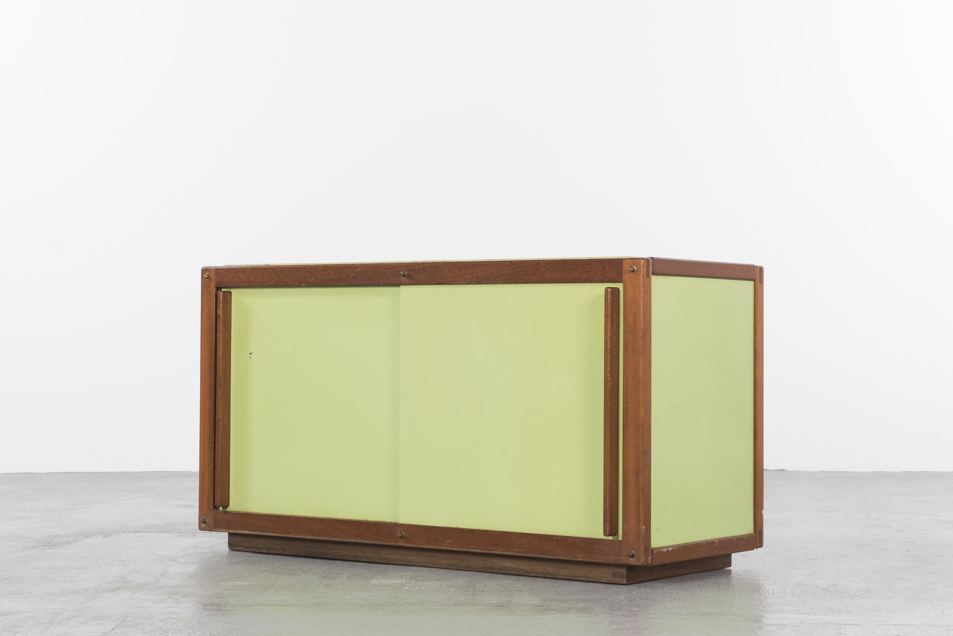 Cabinet in mahogany with 2 lacquered sliding doors designed by French designer André Sornay, circa 1955.
Original classic green.
In very good condition.

This small and elegant piece of furniture is one a series of lacquered cabinets in