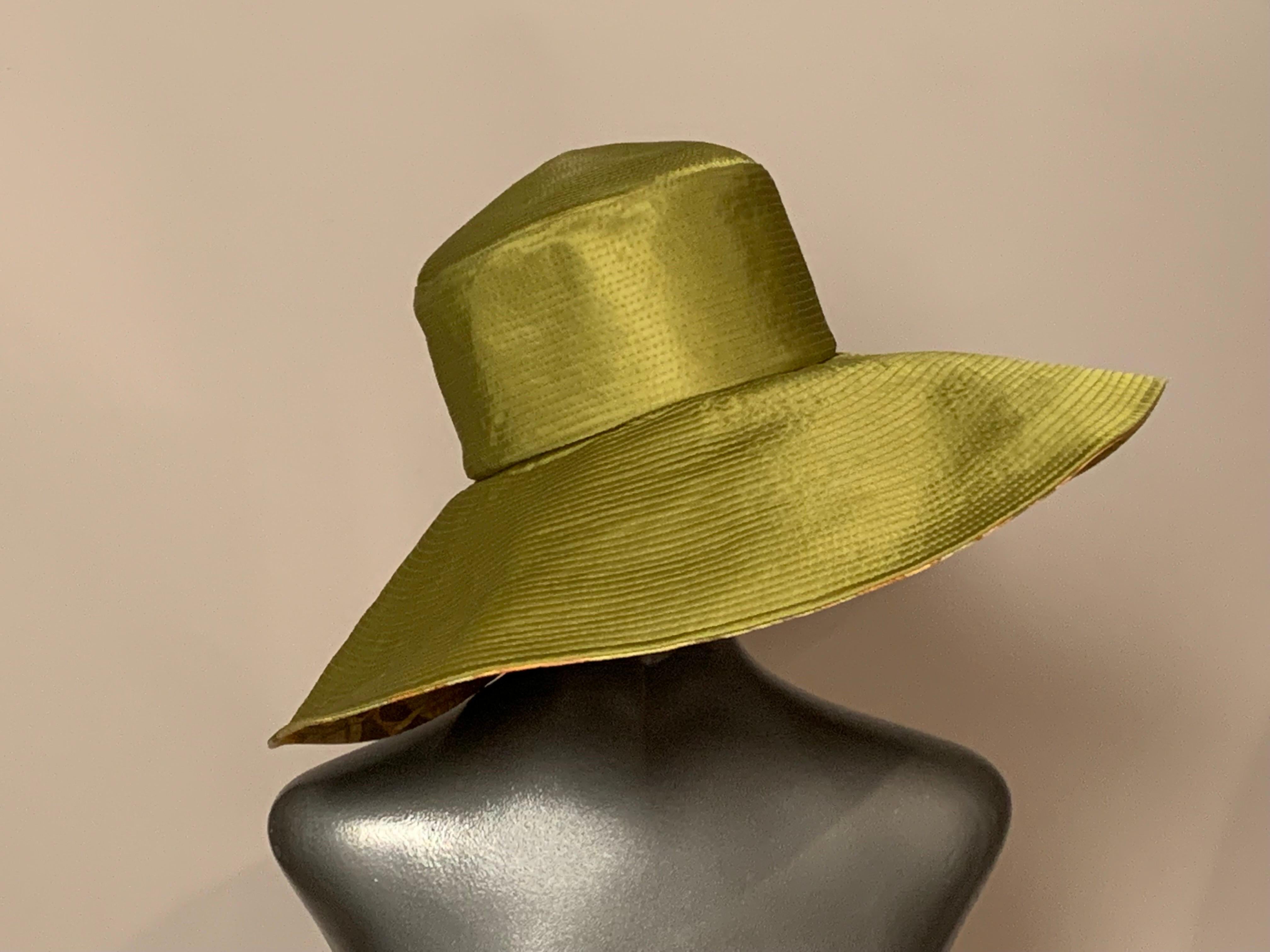 Custom designed and made by Suzanne Couture Millinery on Madison Avenue, NYC this charming hat is made from channel quilted green silk with a cheerful sunflower print brim and lining.  It folds, so it is a perfect travel hat!
Measurements;   Height