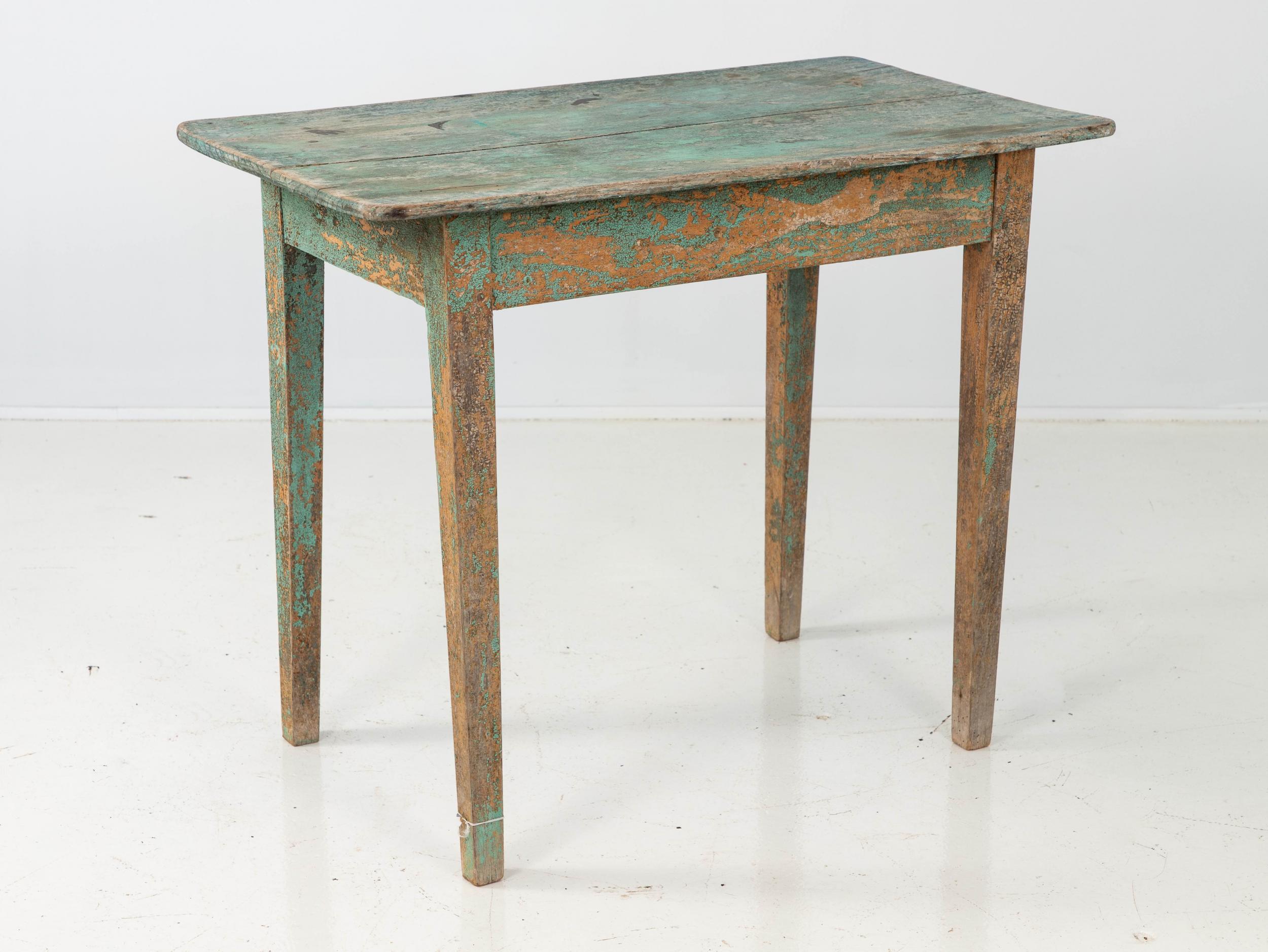 Small Belgian side table in later green paint. Four tapered painted legs. Lovely patina and wear with earlier paints peaking through.
