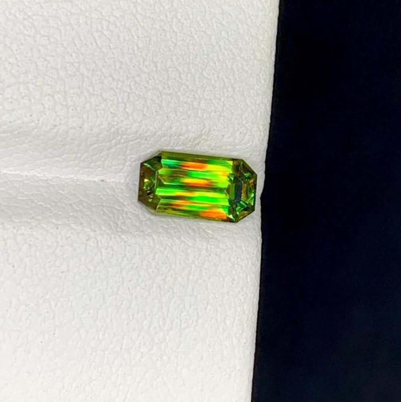 This extraordinary **multicolor sphene** from Pakistan is an absolutely dazzling example of the **titanite** family, bursting with energy and unforgettable brilliance! Sphene is renowned for its exceptional dispersion—often surpassing even