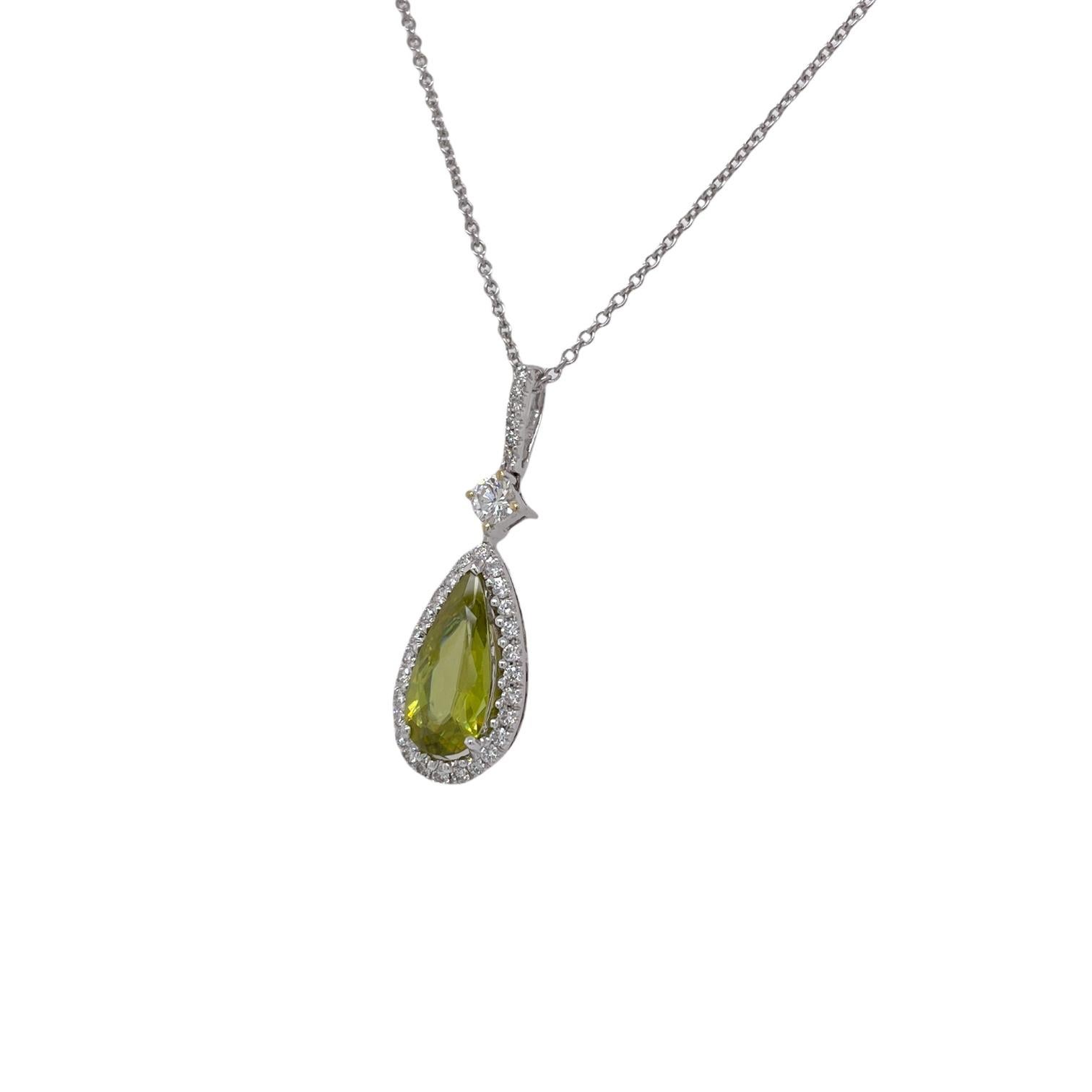 Pendant contains 1 pear shape green spinel weighing 2.08ct. Center stone is surrounded by and hung from round brilliant diamond accents weighing 0.55tcw. Diamonds are near colorless and SI1 in clarity. Pendant hangs from a 16