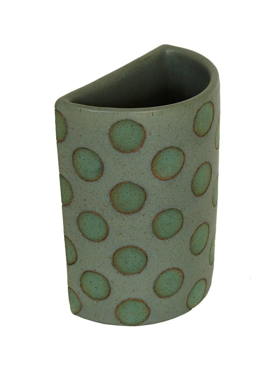Green split polka dot vases by Matthew Ward.
Matthew Ward, born in 1976 in Omaha, NE, is a graduate of the School of the Museum of Fine Arts, Boston, MA (2003). He currently resides in Brooklyn, NY and continues a studio practice including painting