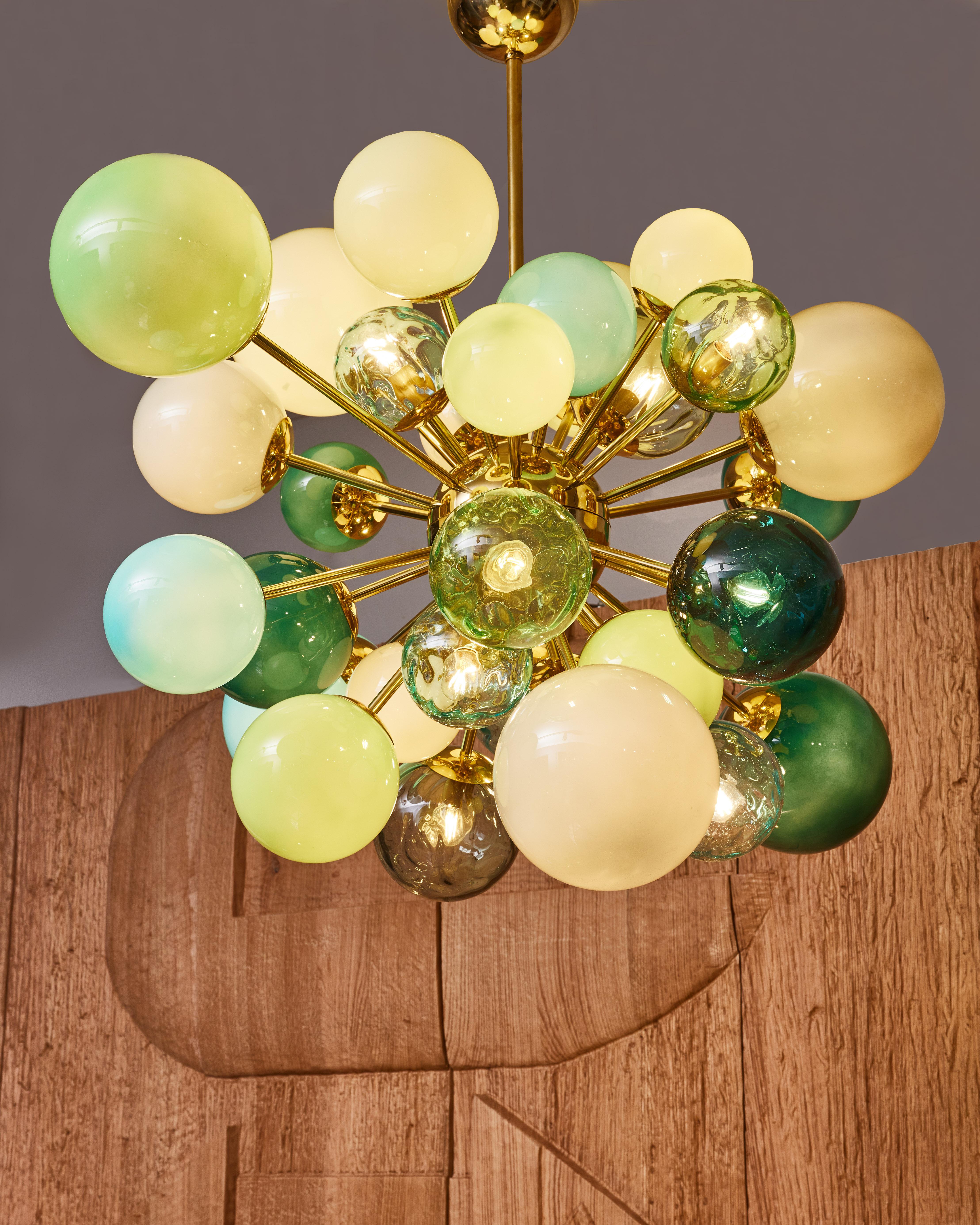 Sputnik chandelier in brass with opaline glass and blown Murano glass globes.
Creation by Studio Glustin.
  