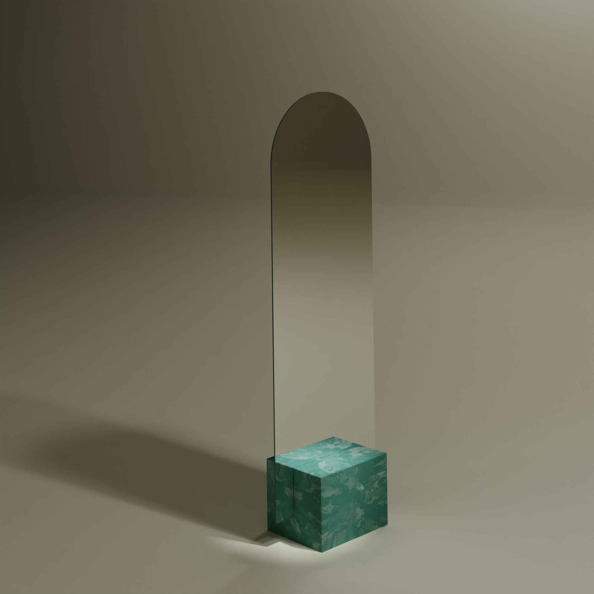Contemporary green standing mirror handcrafted from 100% recycled plastic by Anqa Studios.
With its stone-like bottom and the fragile seeming top part silhouette, the ANQA Moonrise mirror is a modern confluence of both art and function. This