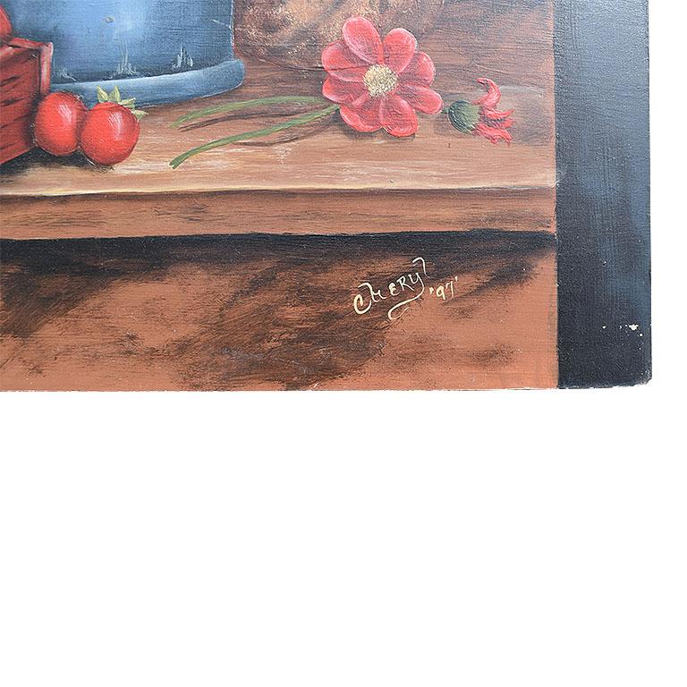 A still life painting of a tabletop with flowers, vegetables, and a watering can. This piece is painted on board and signed at the bottom right. The background is painted in a moody black and blue/grey. The foreground of the piece features a box of