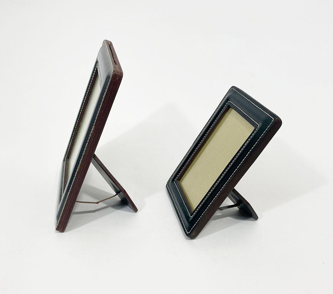 Green stitched leather photo frames

Green leather photo frames with white stitching. 
The photo frame has a slot at the top to slide the glass and photo into.
The measurement is 25 / 19,7 cm high, 20 cm / 14,7 cm wide and the depth is 1,5 cm
The