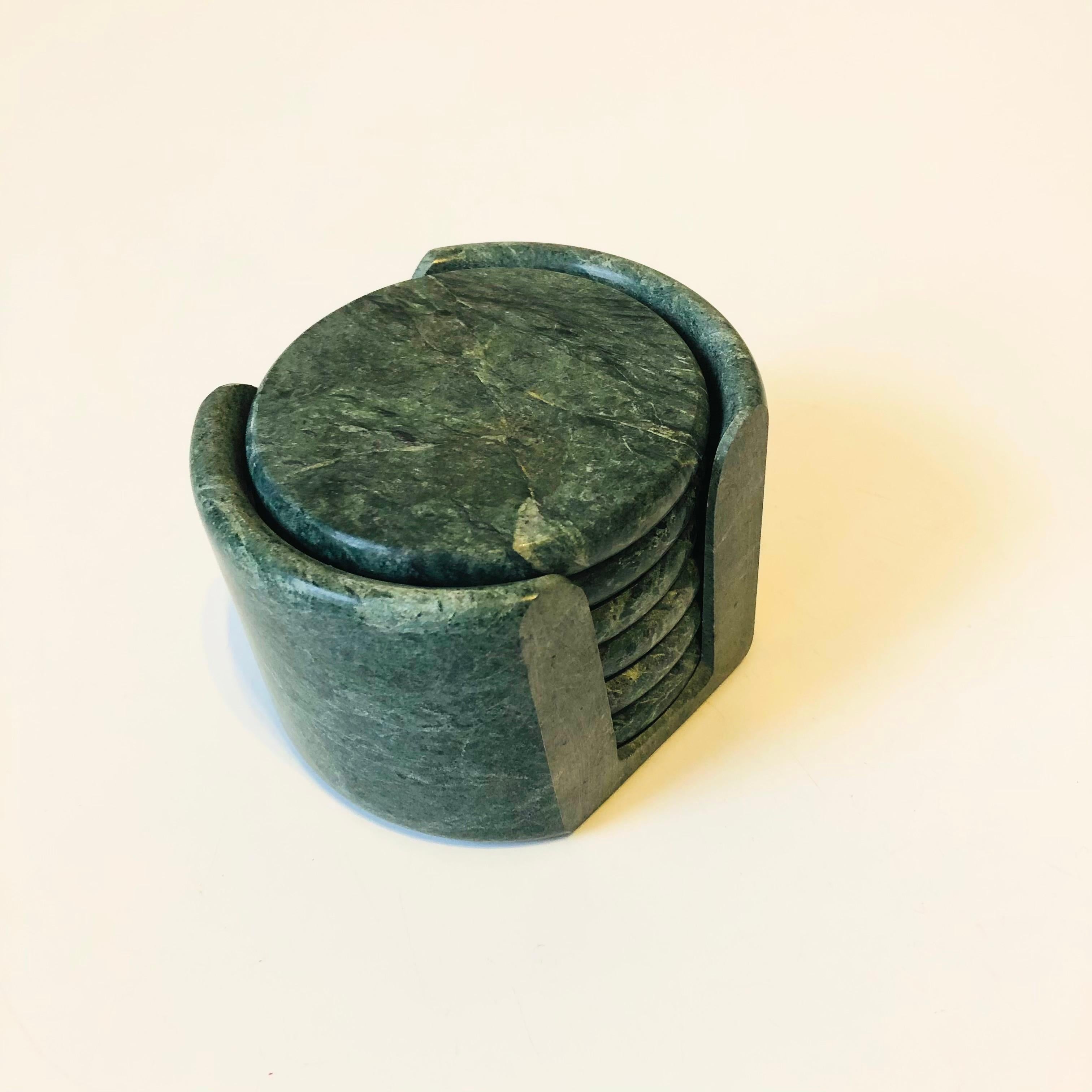 A set of 6 vintage green stone coasters in a matching holder. Each is made of a lovely circular slab of stone with beautiful natural veining. Cork backings to the coasters.

