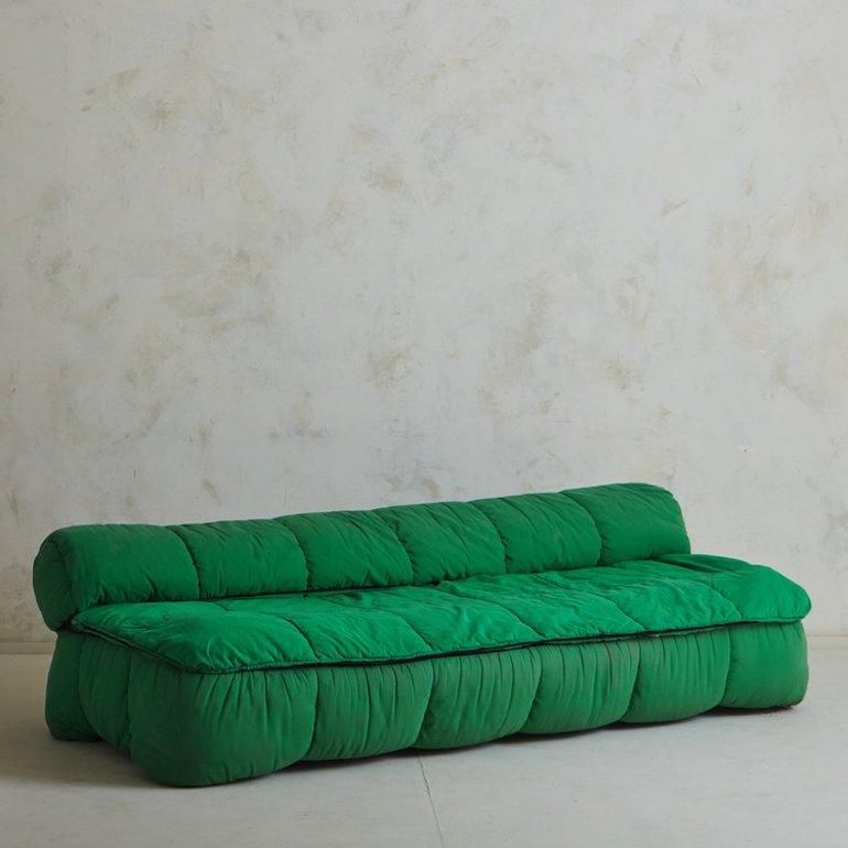 An Italian ‘Strips’ sofa designed by Cini Boeri for Arflex in the late 1960s. This sofa has a removable green fabric cover with channels and ruched detailing. It has a low profile and can be used as a sofa or converted into a bed. Retains ‘Strips
