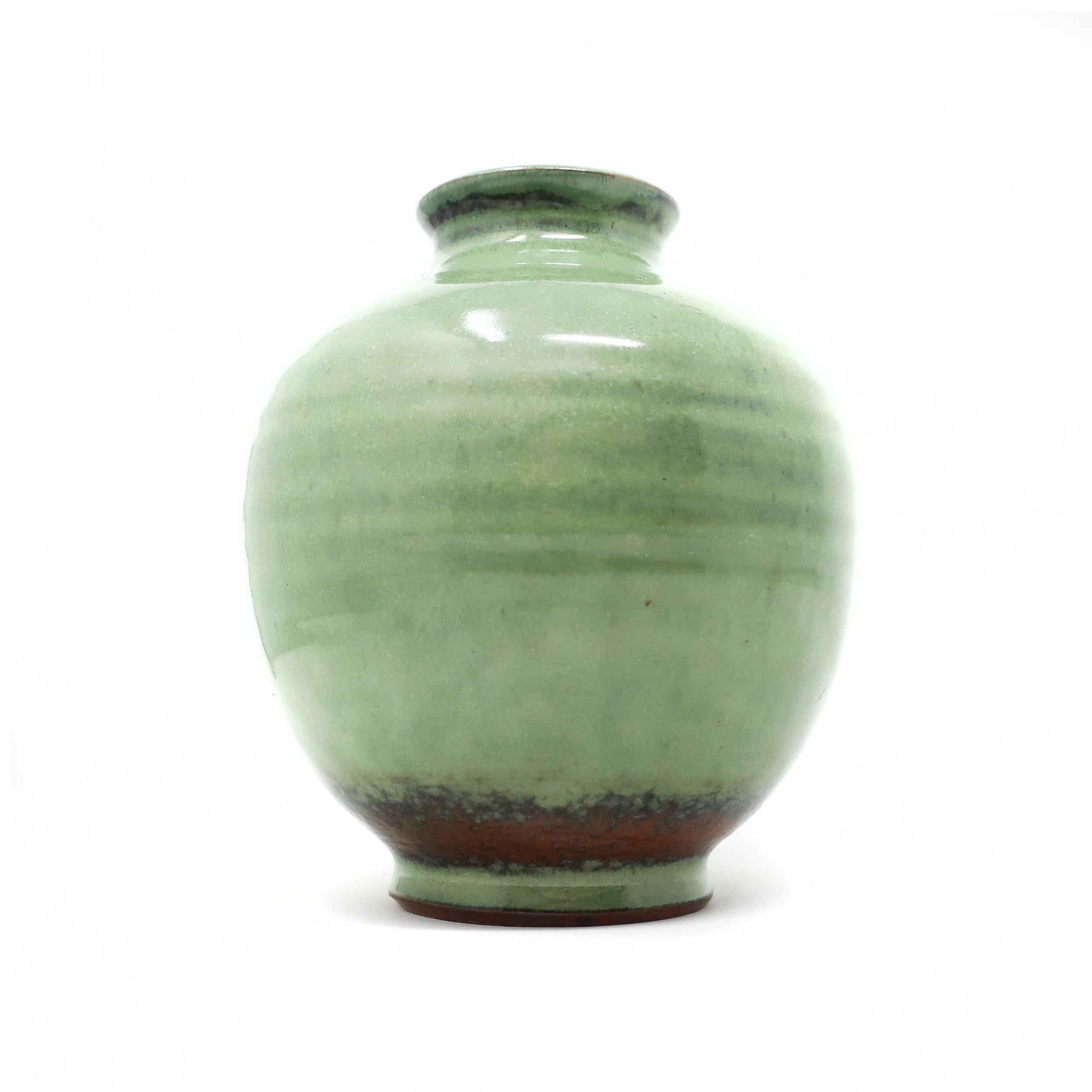 A lovely celadon or greenware ceramic vase by Edwin & Mary Scheier, one of the best known couples to ever work in pottery. Edwin (1910-2008) and Mary (1908-2007)began creating together in the 1930s. This piece has a beautiful light green glaze with