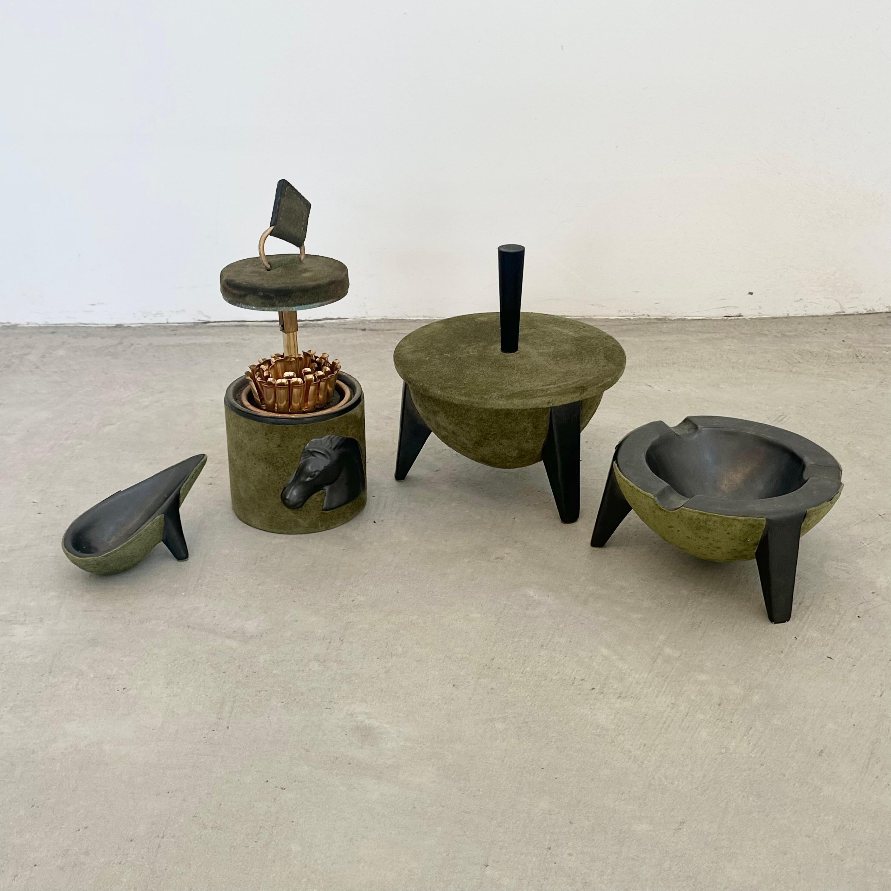Absolutely gorgeous olive green suede and ceramic smoking set by Longchamp. Each piece is unique in its own way, but together as a set of four they create a beautiful and timeless collection. 

Cigarette holder opens up to reveal a cigarette