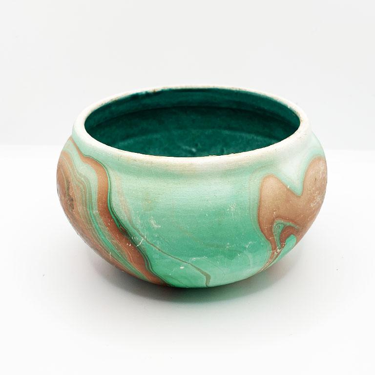 A beautiful green, brown, and cream touring pot or planter. This piece is glazed on the interior in rich emerald verdigris blue-green glaze and will be perfect for use as a planter. 

Bottom reads in black:
Made in Cripple Creek