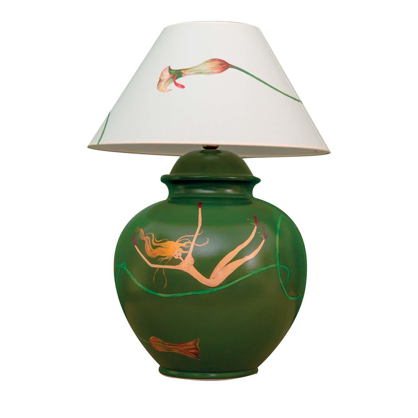 This magnificent piece is the result of masterful, traditional craftsmanship. A versatile and timeless table lamp, it is composed of a base fashioned of green-polished clay, and a white fabric lampshade decorated by hand with a delicate calla
