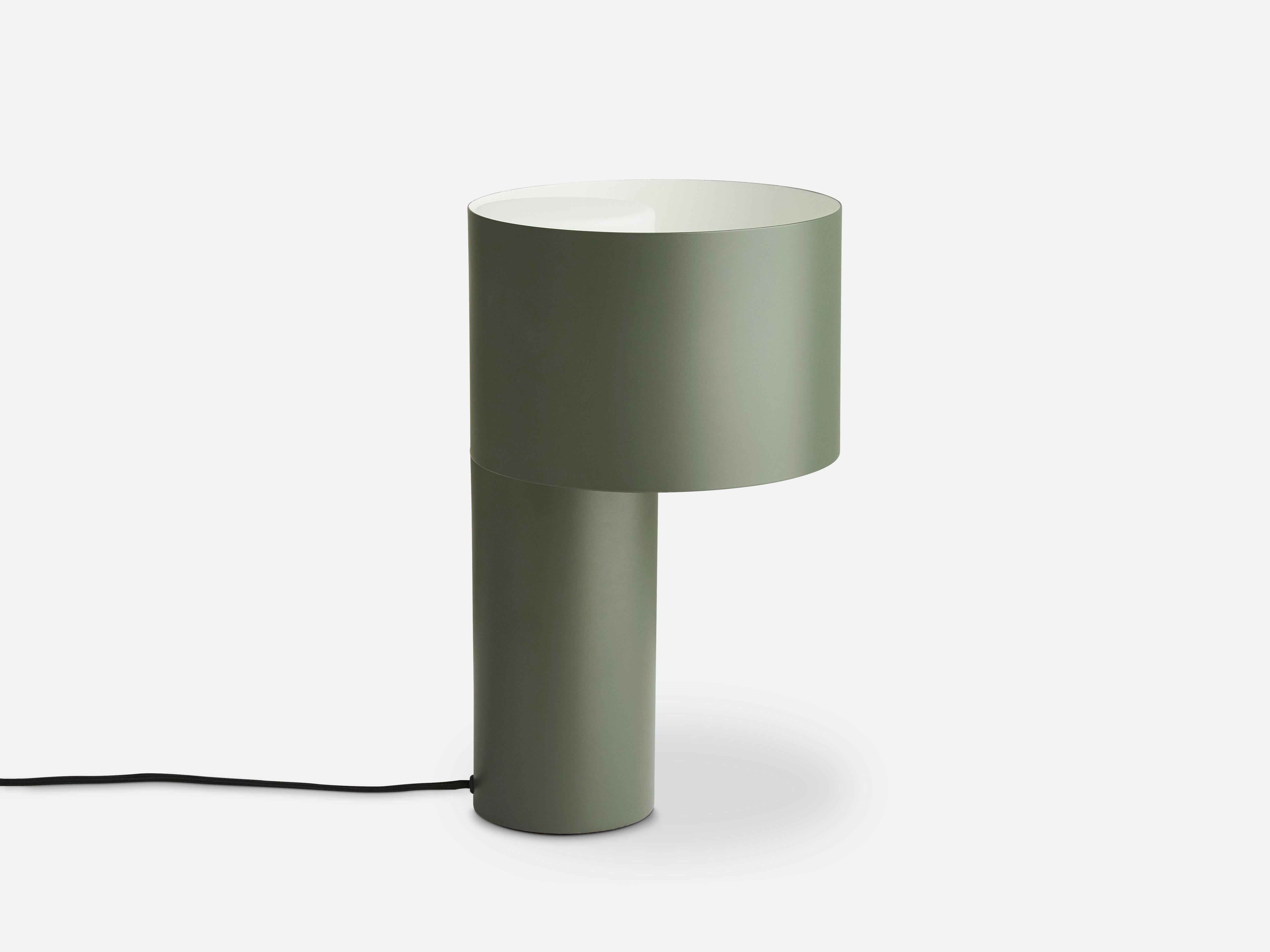 Green tangent table lamp by Frederik Kurzweg.
Materials: Metal, glass.
Dimensions: D 20 x H 34 cm.
Available in Forest green, desert sand and cool grey.

Frederik Kurzweg is an upcoming design talent born in Germany. His background as a trained