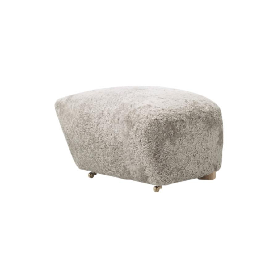 Green tea natural oak sheepskin the tired man footstool by Lassen
Dimensions: W 55 x D 53 x H 36 cm 
Materials: Sheepskin

Flemming Lassen designed the overstuffed easy chair, The Tired Man, for The Copenhagen Cabinetmakers’ Guild Competition in