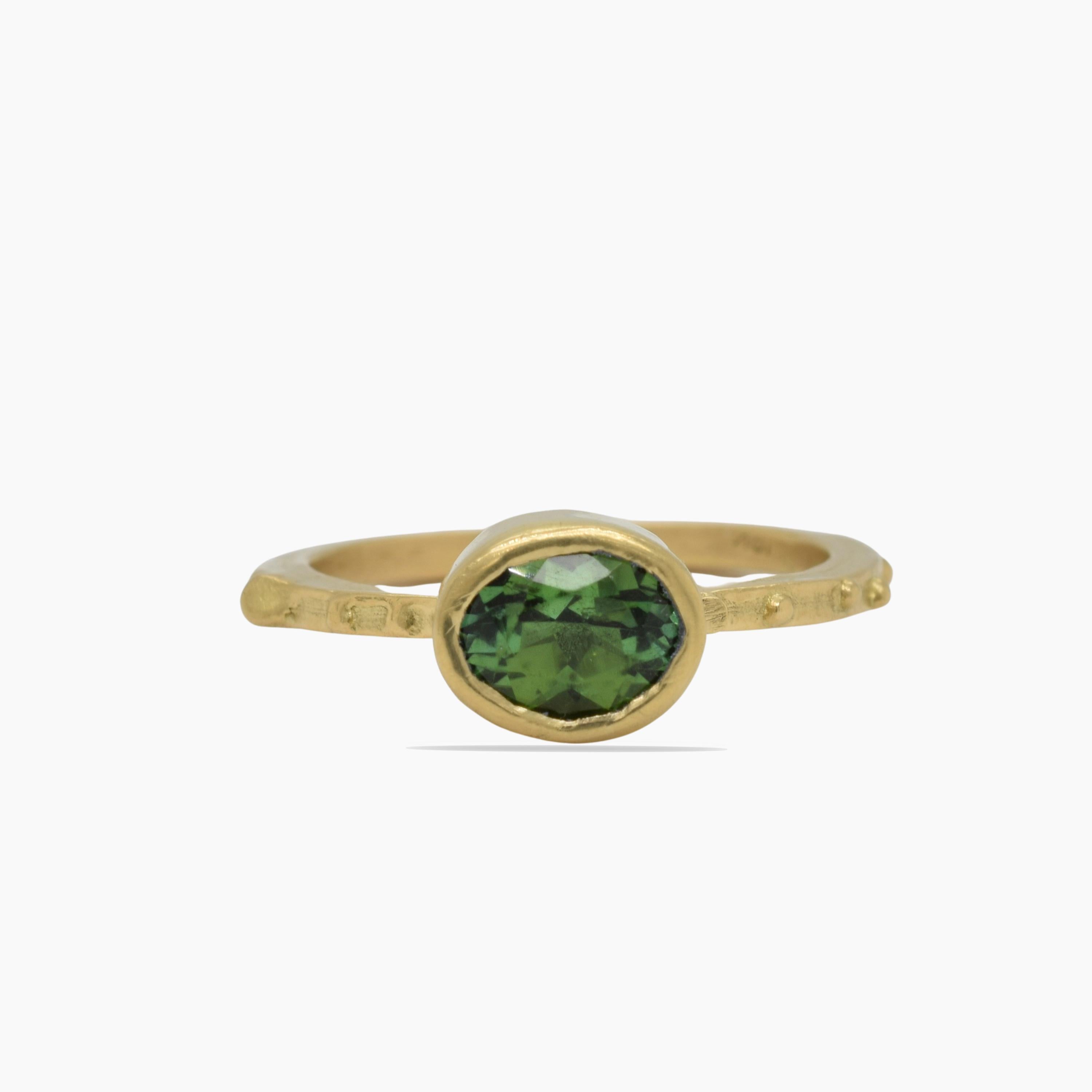 A pretty sweet 1.27 Carat Green Tourmaline is simply set in this 18K bezel and 18K grainy stacking band.  Hand fabricated and one of a kind.  Stacks well with my other Lorelei rings.

Size- 6-1/4