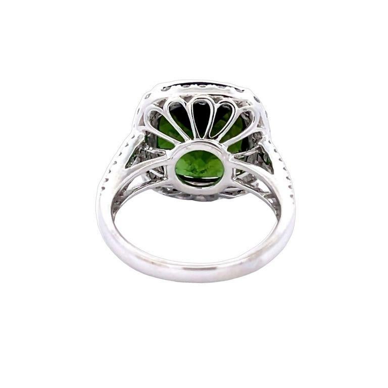 Let us introduce you to our cushion-shaped ring, will undoubtedly captivate your heart with its stunning green tourmaline gemstone that exudes a beautiful color in every movement. The centerpiece of this magnificent ring features a remarkable