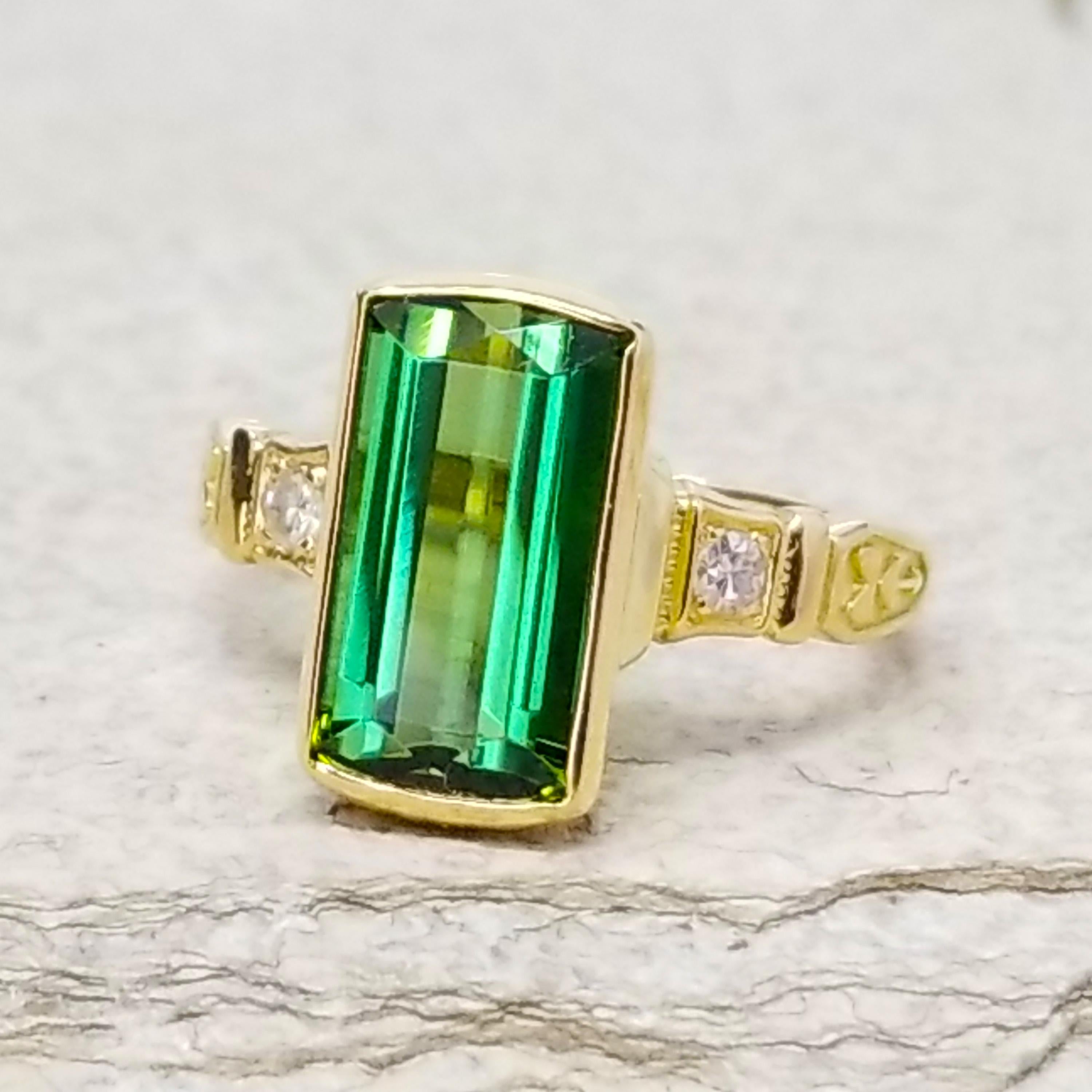 The Ivy Ring blends a distinctly Art Deco motif with a cool and modern setting which showcases a gemstone beautifully. This version features a richly-hued green tourmaline in a unique custom cut; the long bar-shaped facets on the back of the stone