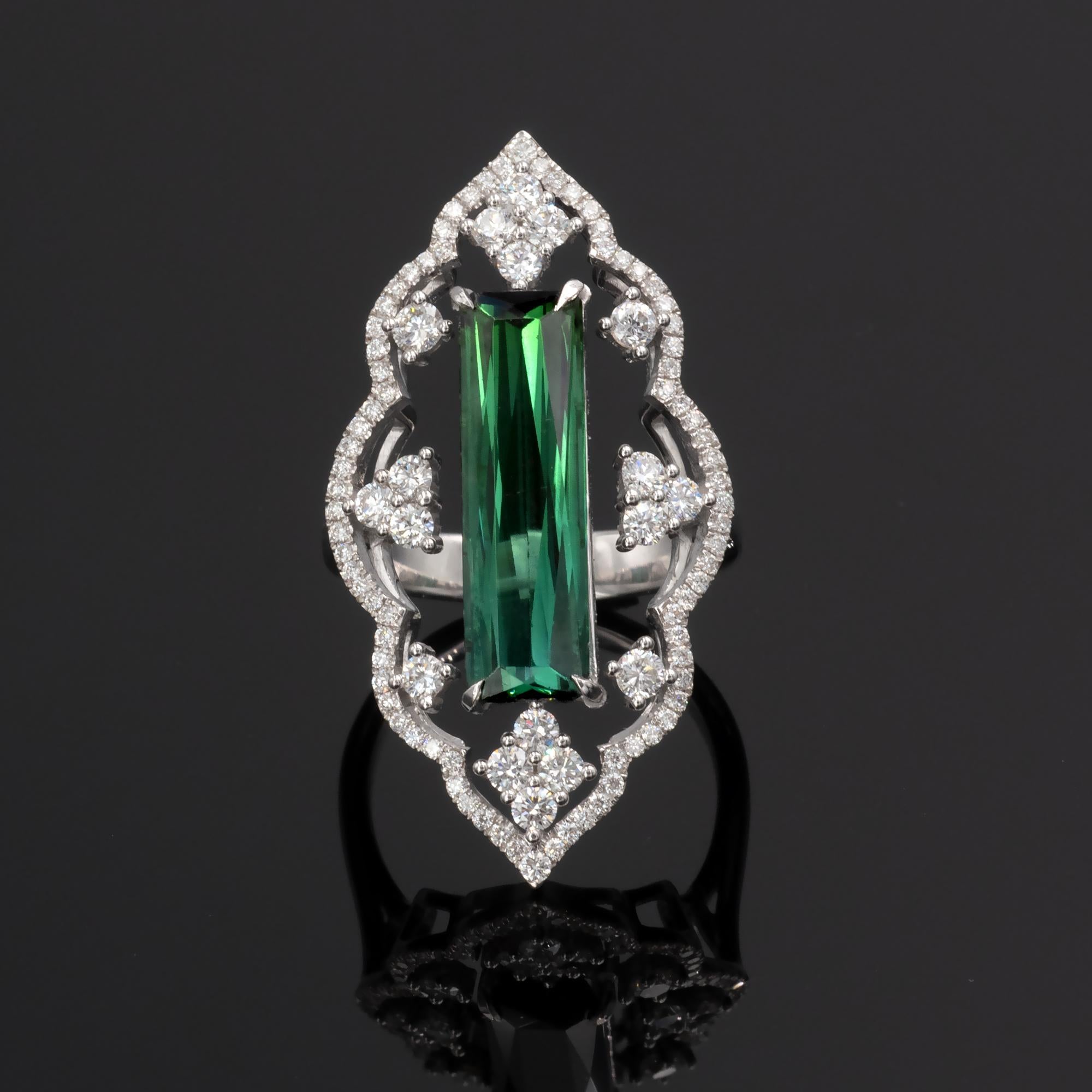 Lace like white gold and and tightly set diamond ring showcasing a long green tourmaline.
Diamonds : 1.22 carats (G VS or better), Tourmaline 4,46 carat
The ring bears the french 18 Karat hallmark stamp.

