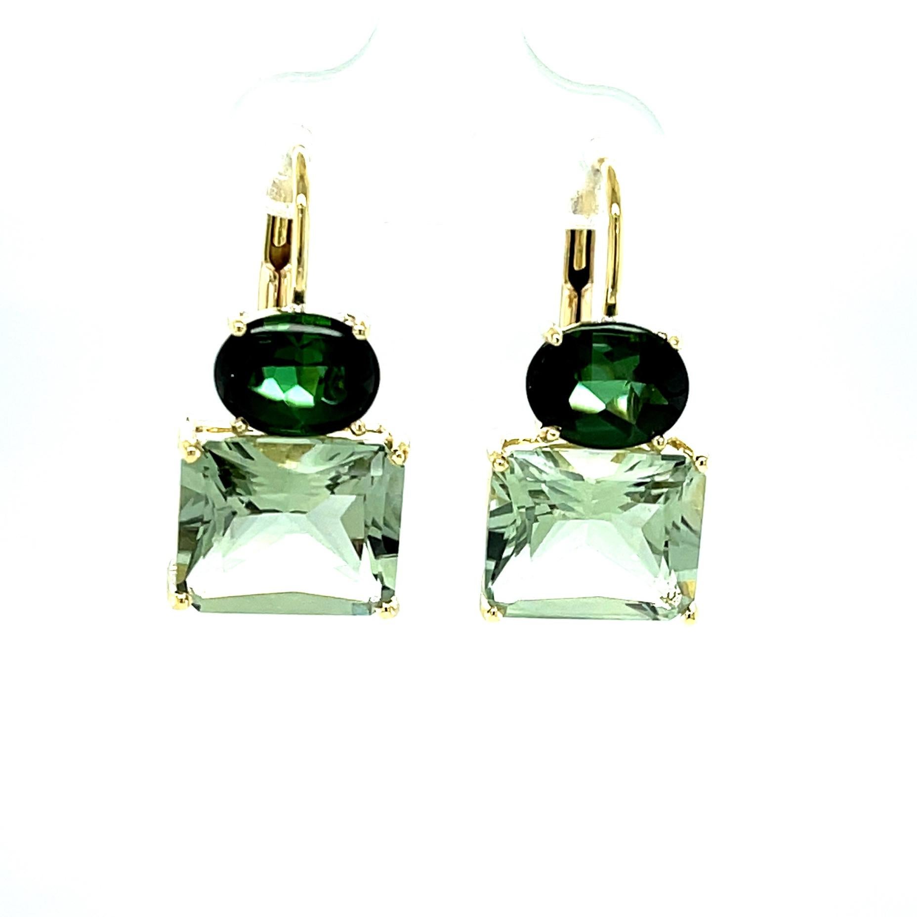 These bright green tourmaline and quartz drop earrings are not only pretty and unique, they are also versatile and can be worn in any season! Two richly colored green tourmaline oval cabochons are set east-west on top, and exhibit extra brilliance