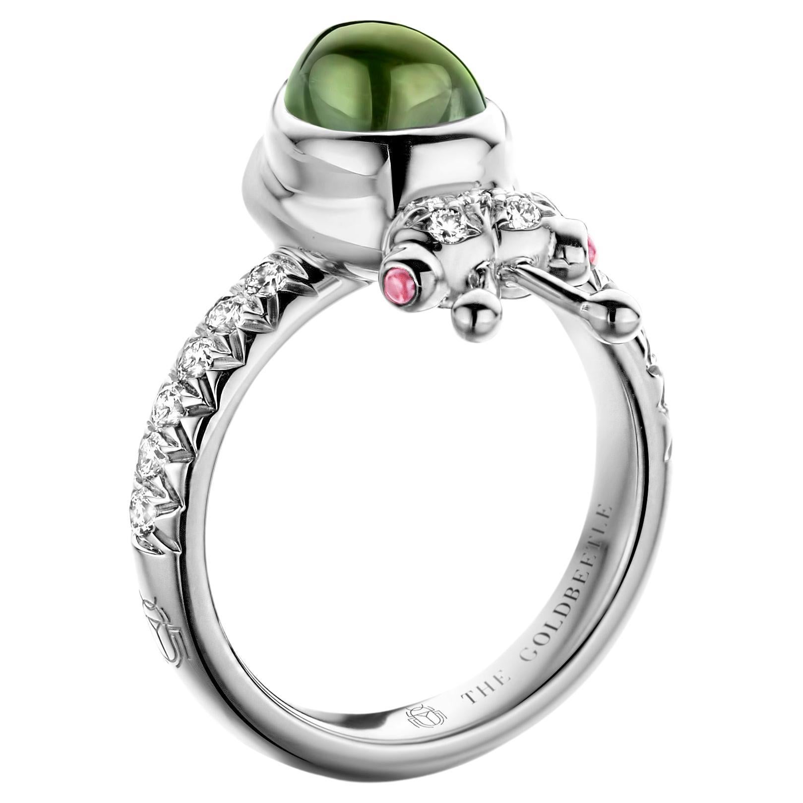 One-of-a-kind lucky beetle ring in 18-Karat white gold 8,6 g set with the finest diamonds in brilliant cut 0,34 Carat (VVS/DEF quality) one natural, green tourmaline in pear cabochon cut and two pink tourmalines in round cabochon cut.
