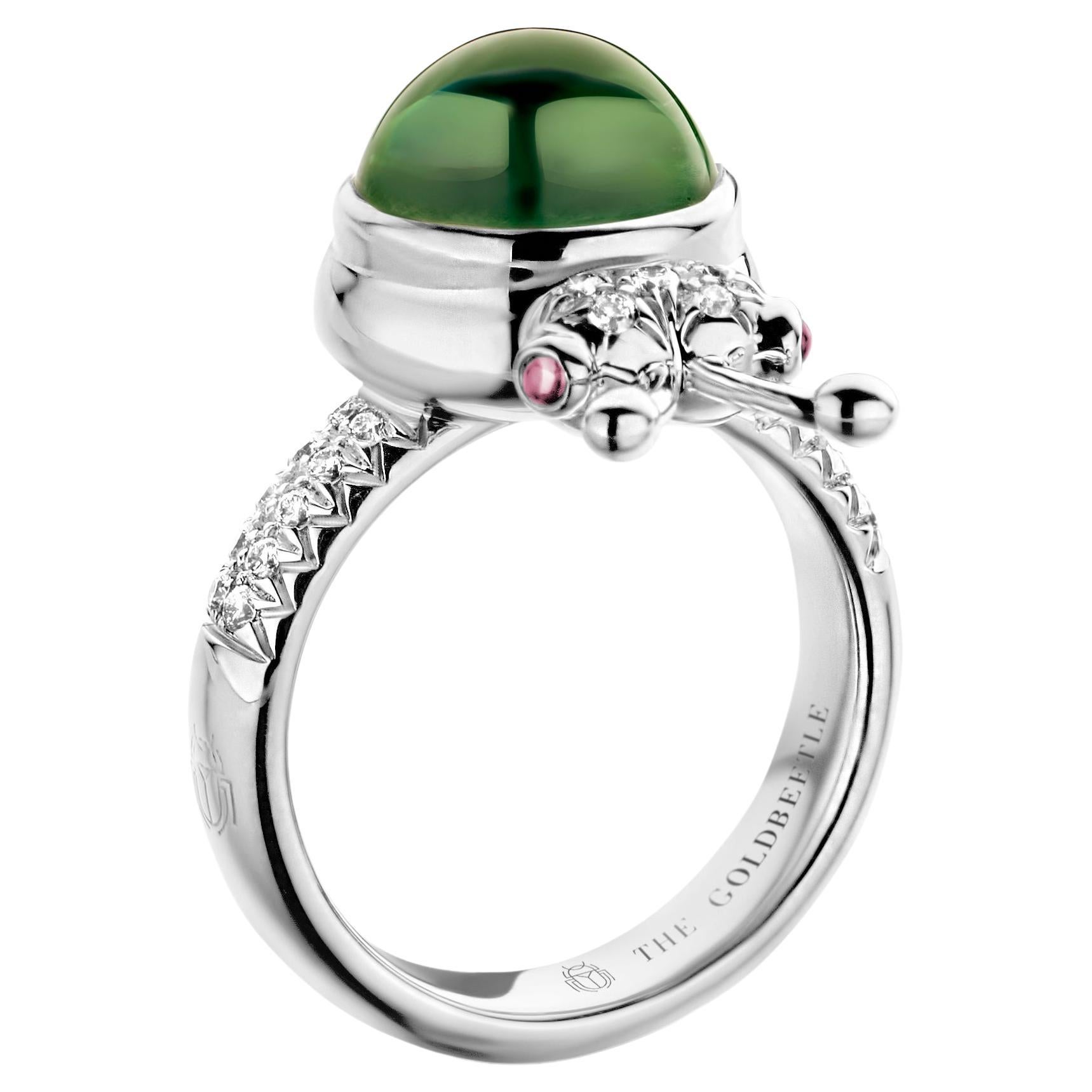 One-of-a-kind lucky beetle ring in 18-Karat white gold 10g set with the finest natural diamonds in brilliant cut 0,23 Carat (VVS/DEF quality) one natural, green tourmaline in round cabochon cut 6,00 Carat and two pink tourmalines in round cabochon