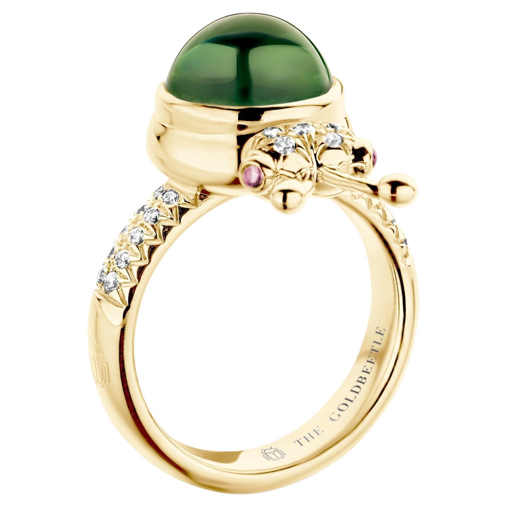 One-of-a-kind lucky beetle ring in 18-Karat yellow gold 10g set with the finest natural diamonds in brilliant cut 0,23Ct (VVS/DEF quality) one natural, green tourmaline in round cabochon cut 6,00 Carat and two pink tourmalines in round cabochon cut.