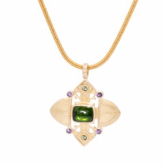 Green Tourmaline Ashanti Cross Pendant in 18 Karat Gold with Purple Sapphires