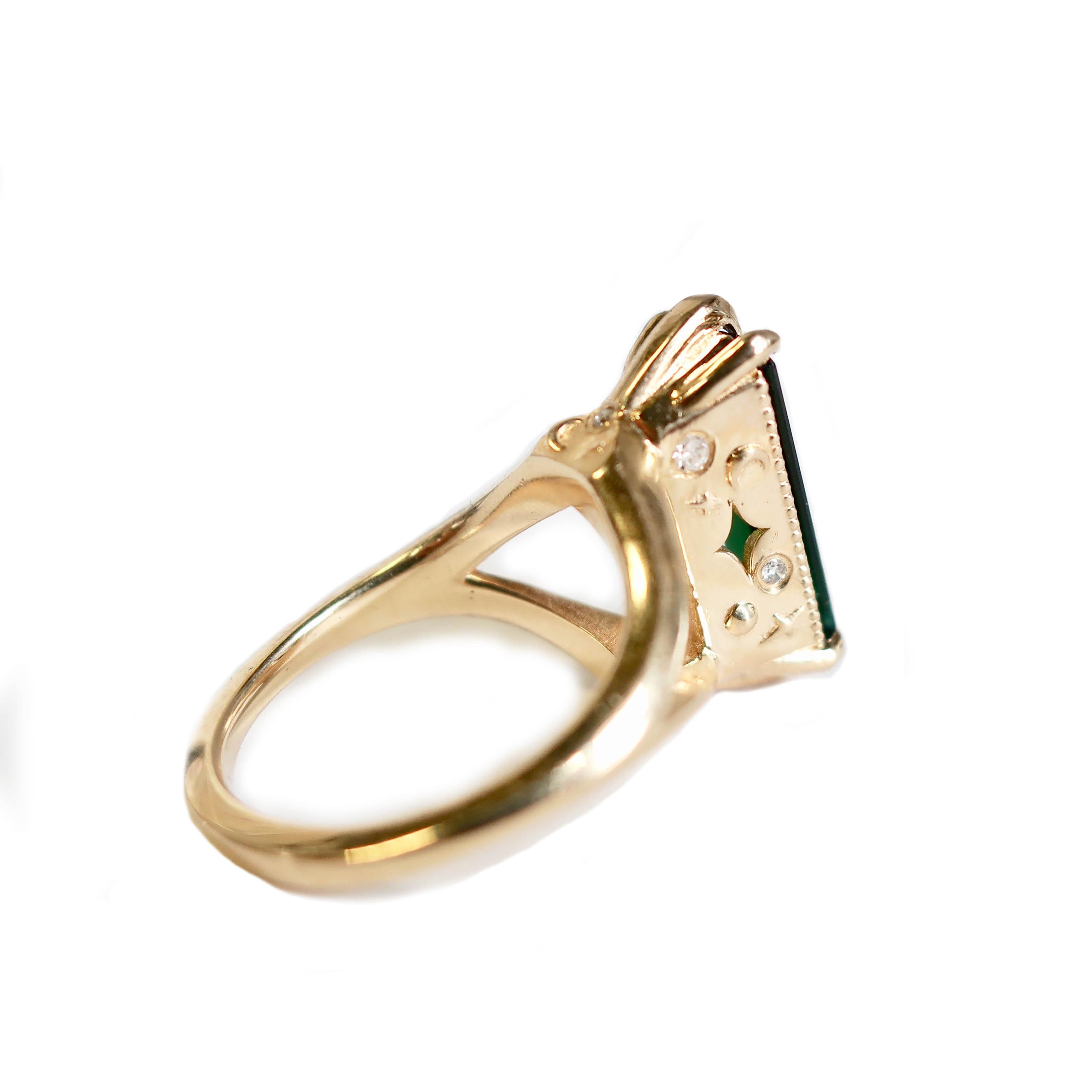 This vibrant green and blue bi color tourmaline sits in beautiful 14K yellow gold. A star and moon motif on either side with a few small 1mm pave diamond accents on the sides. Delicate beading frames the sides. Ring basket sits high (10mm) and