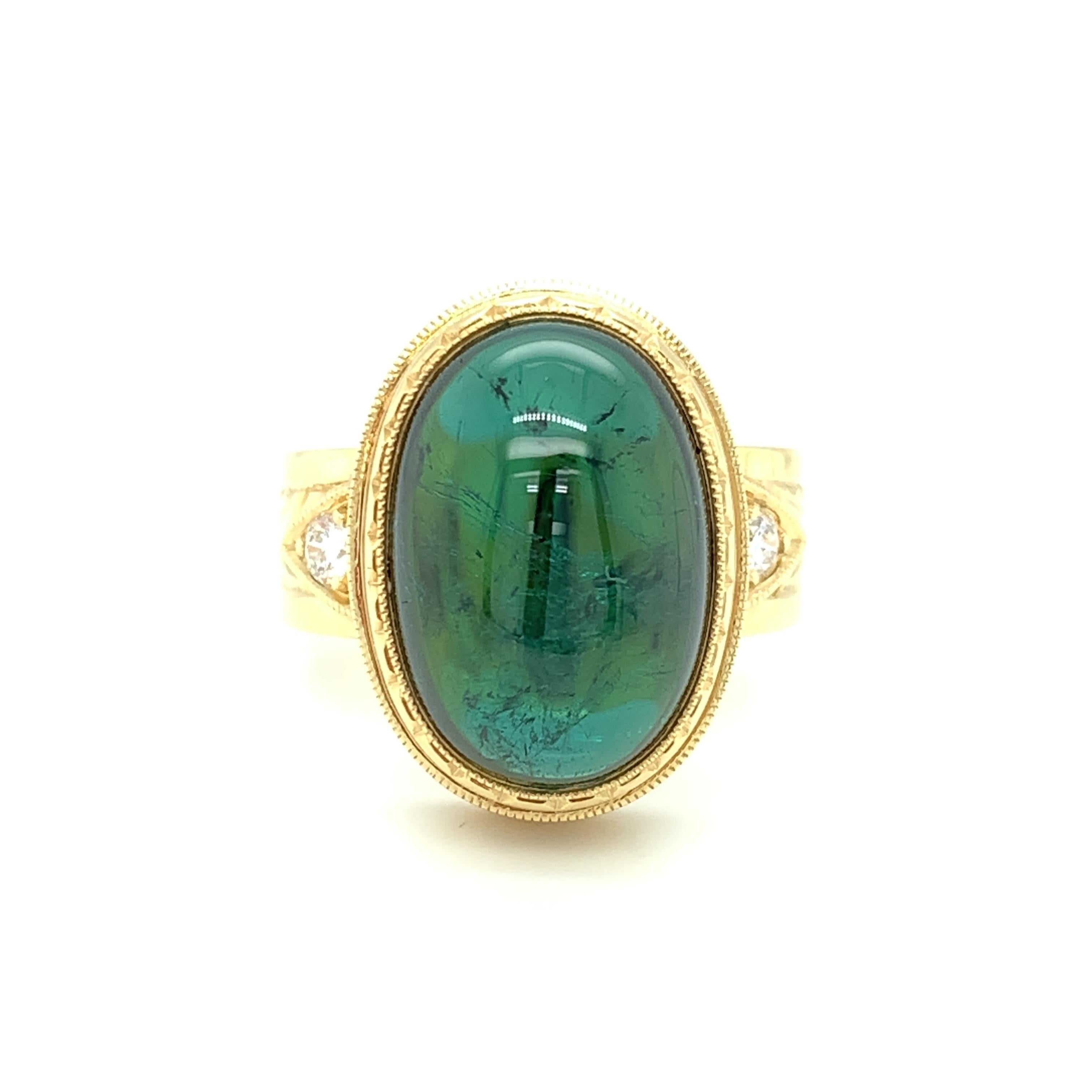 A large, rich 14.01 carat teal green tourmaline cabochon is the focal point of this custom-made signature ring, specially designed for this lovely gem. The tourmaline cabochon is bezel set by hand with a level of precision and skill seldom seen