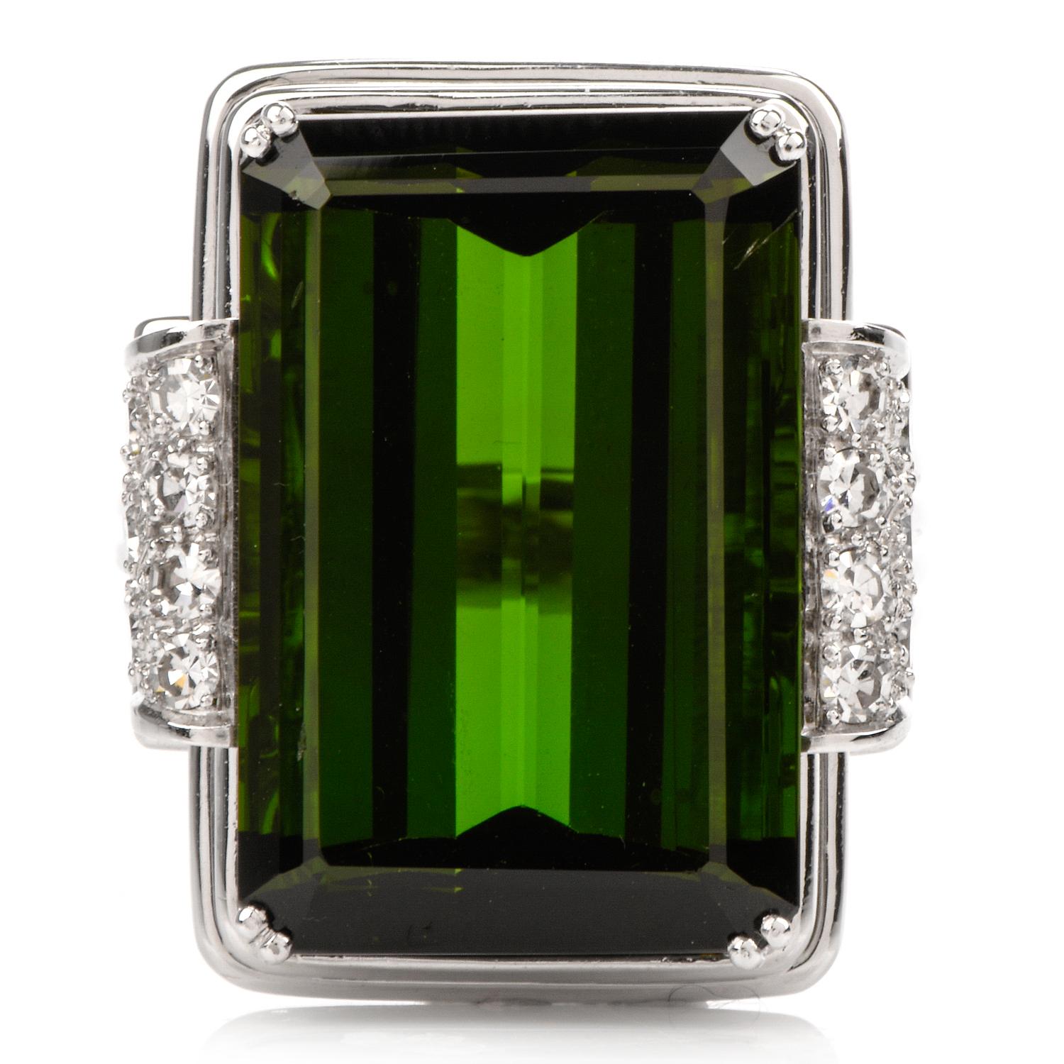 This classy tourmaline and diamond statement ring is crafted in solid 18-karat white gold, weighing 14 grams and measuring 22mm x 8mm high. Displaying a prominent prong-set, rectangular tourmaline of deep green color, weighing approximately 17.47