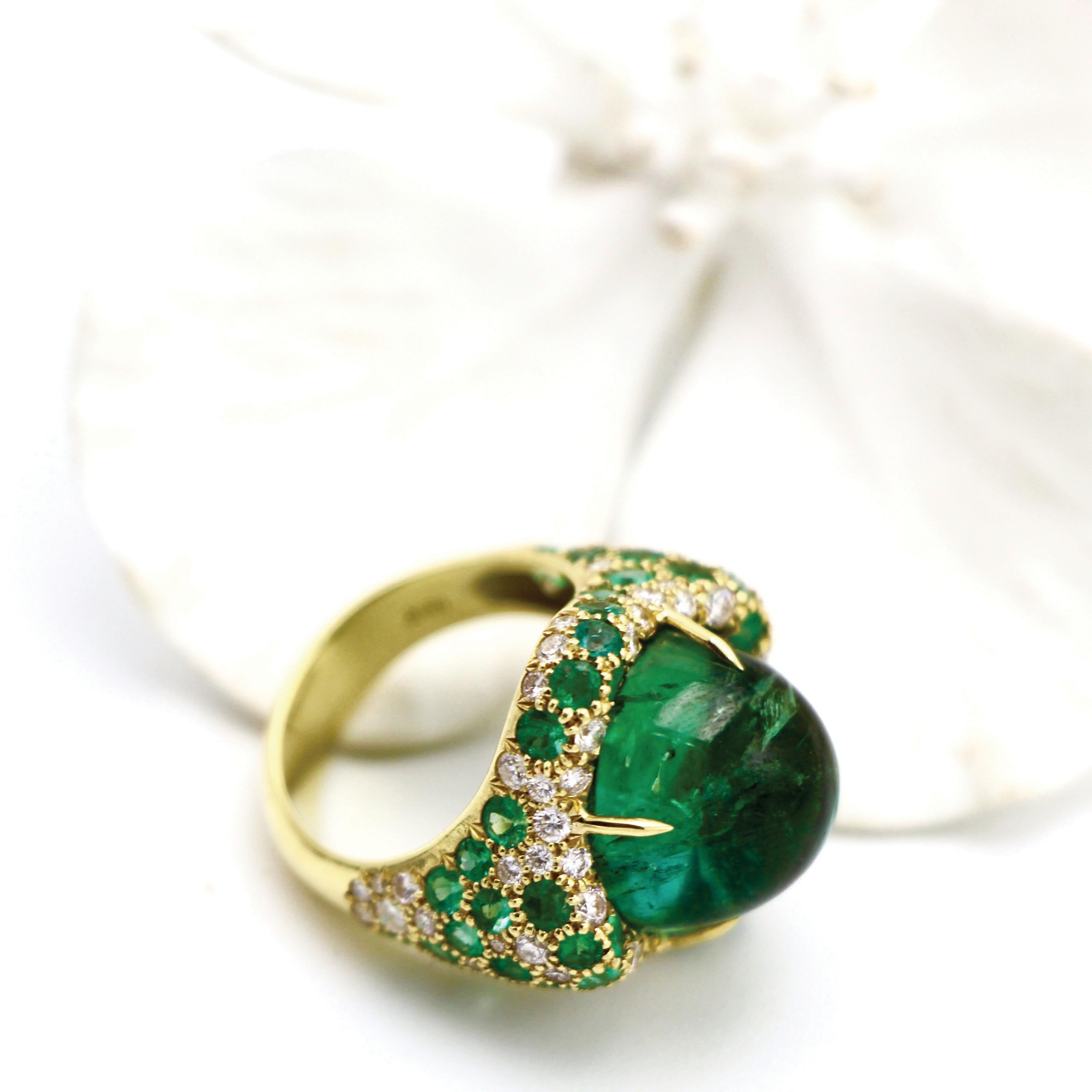 The stunning Green Tourmaline (17.75ct) set off by Diamonds (1.33ct) and Emeralds (2.59ct) in an 18kt Gold band will turn any heads at the next Met Gala. 

Dimensions of Green Tourmaline: 14.43mm
Dimensions of Face of Ring: 23.02mm x 22.65mm