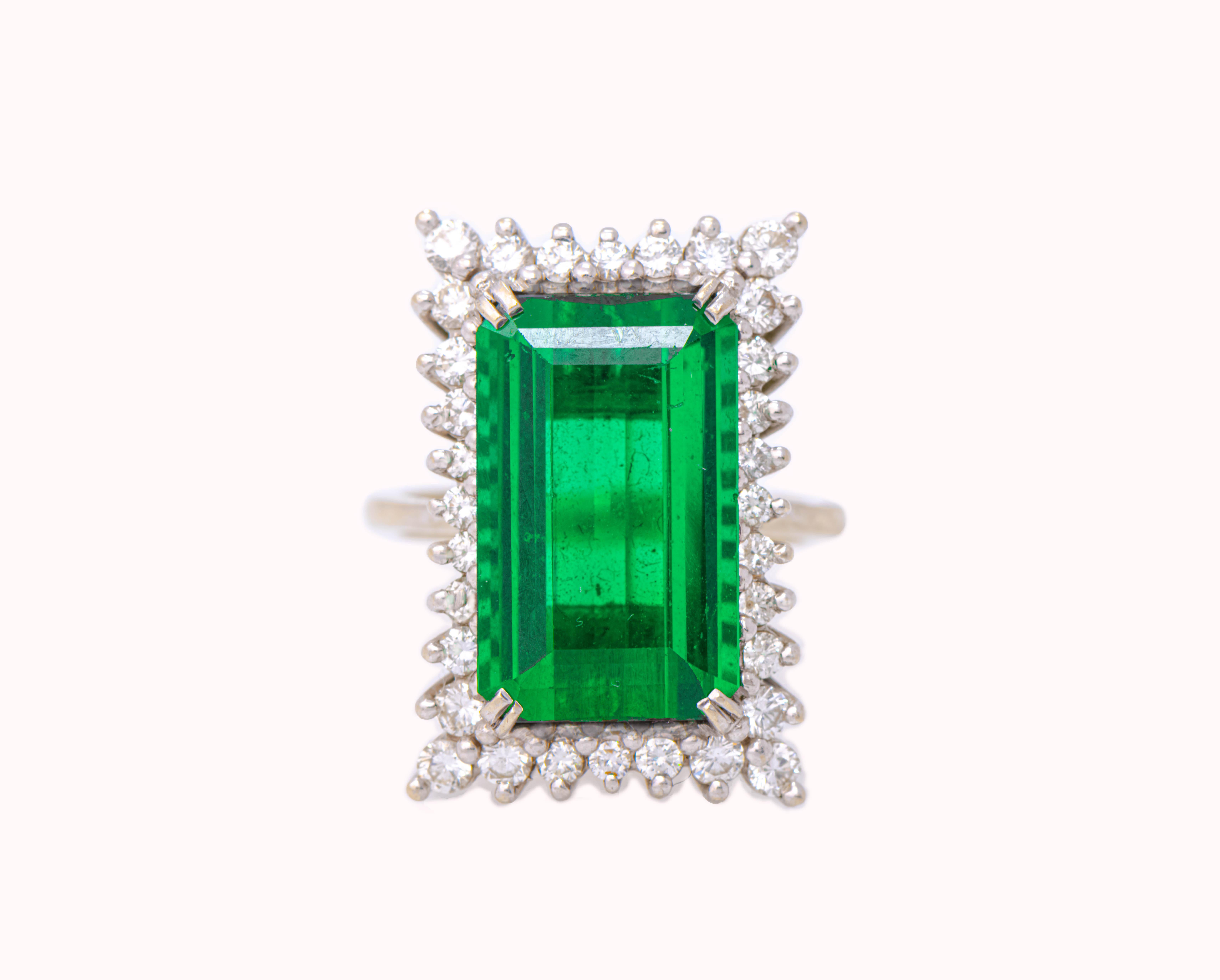 Emerald Cut Green Tourmaline & Diamond Cocktail Ring, a center green tourmaline set with round cut  diamonds.

Tourmaline Weight: 8.37 cts 
Diamond Weight: .83 cts 

Ring Size: 6.75

Resizable free of charge 

Metal Type:  14K White Gold 