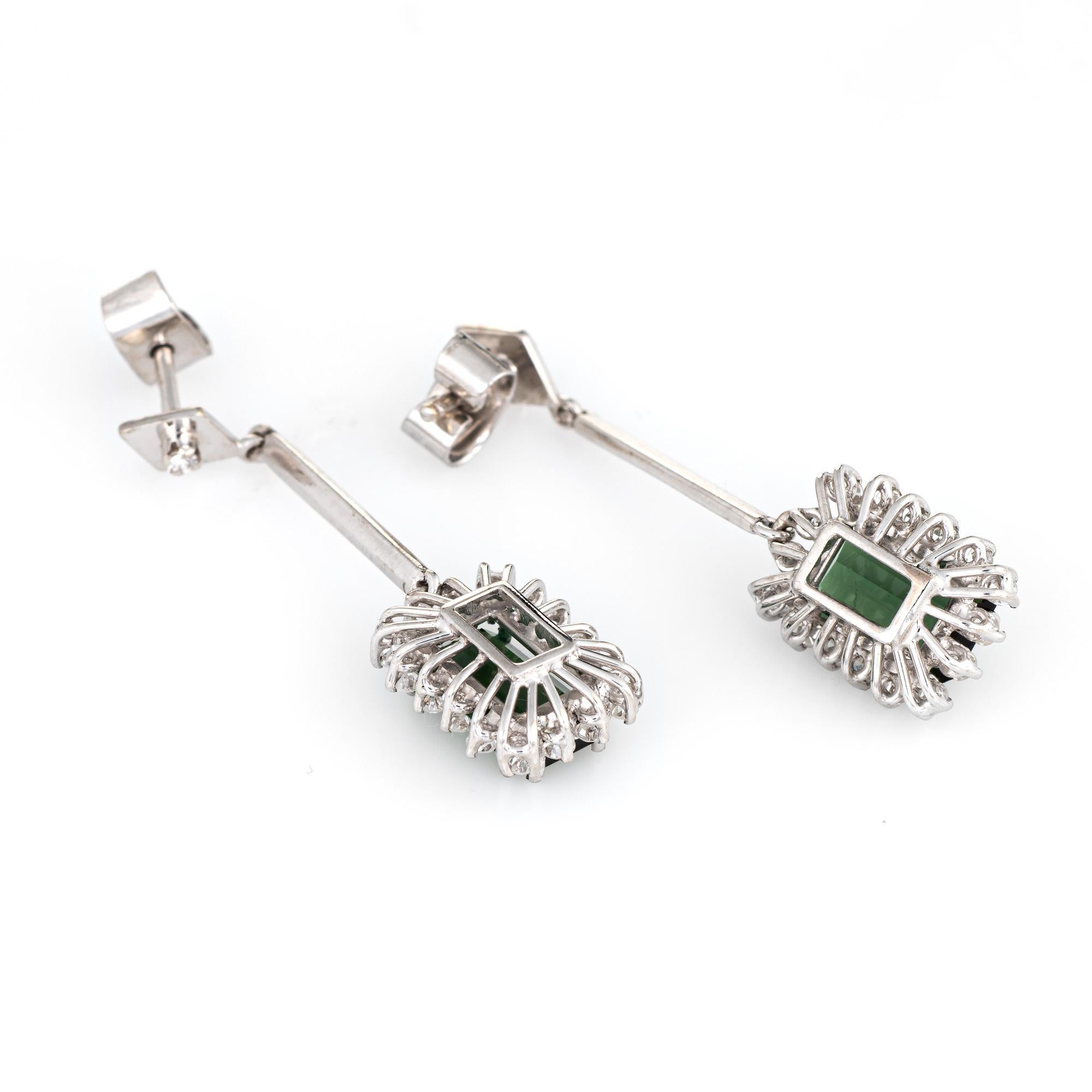 Elegant pair of vintage green tourmaline & diamond drop earrings crafted in 18k white gold. 

Green tourmalines measure 9mm x 5.5mm (estimated at 1.75 carats each - 3.50 carats total estimated weight), accented with an estimated 0.32 carats of
