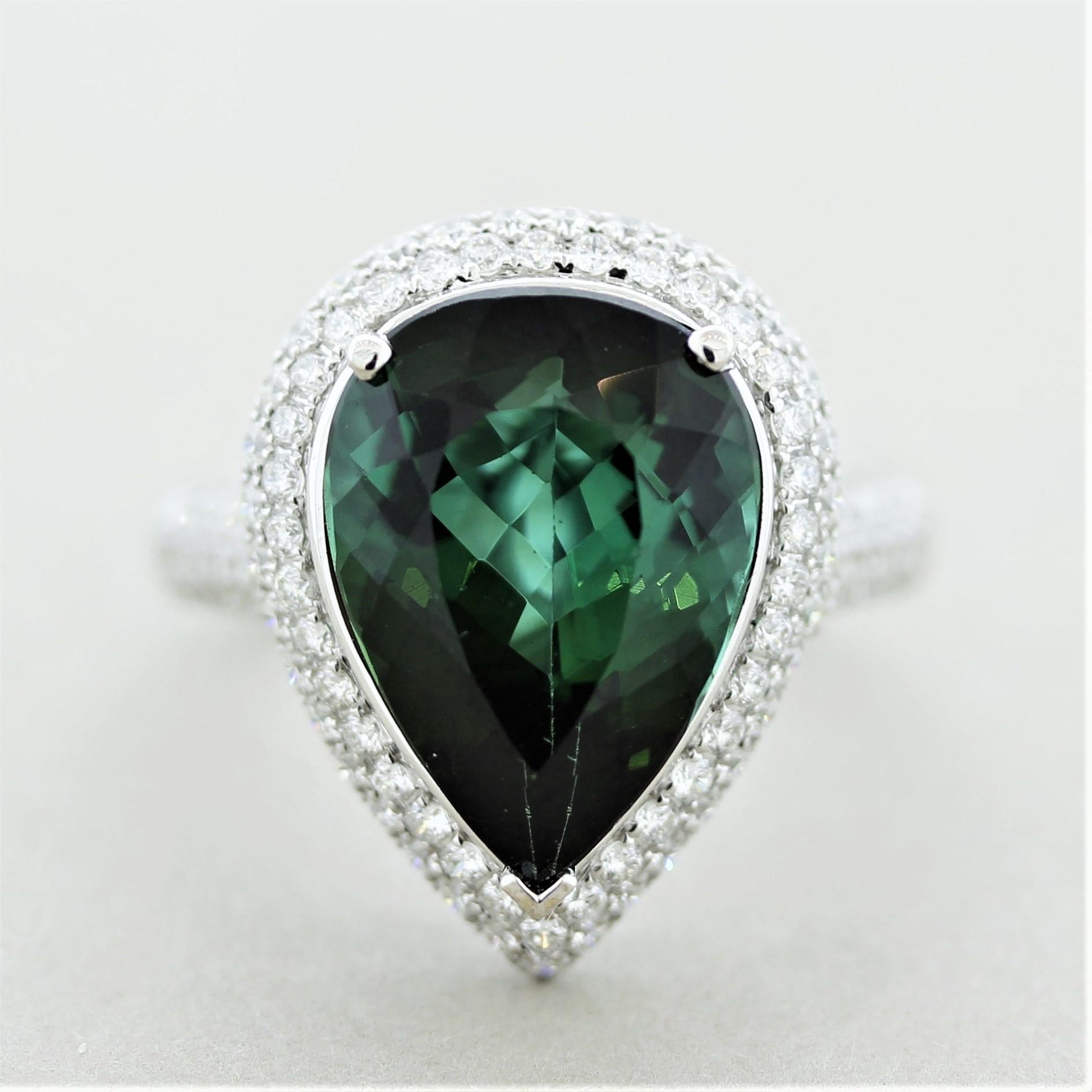 A sweet and stylish ring featuring a gem tourmaline weighing 7.11 carats. It has a rich and intense green color and is free from any eye-visible inclusions. Accenting the tourmaline are 0.86 carats of fine round brilliant-cut diamonds which are